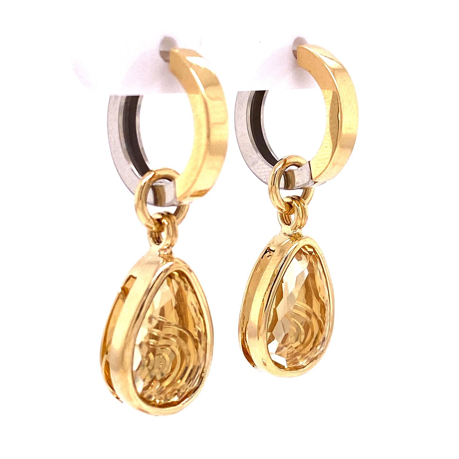 A pair of reversible 18k white and yellow gold huggie hoops and, a pair of 18k yellow gold 13.4mm x 9mm pear shaped antique cut yellow beryl jackets with yellow gold back plates hand engraved with klimt inspired spiral patterns . These jackets were