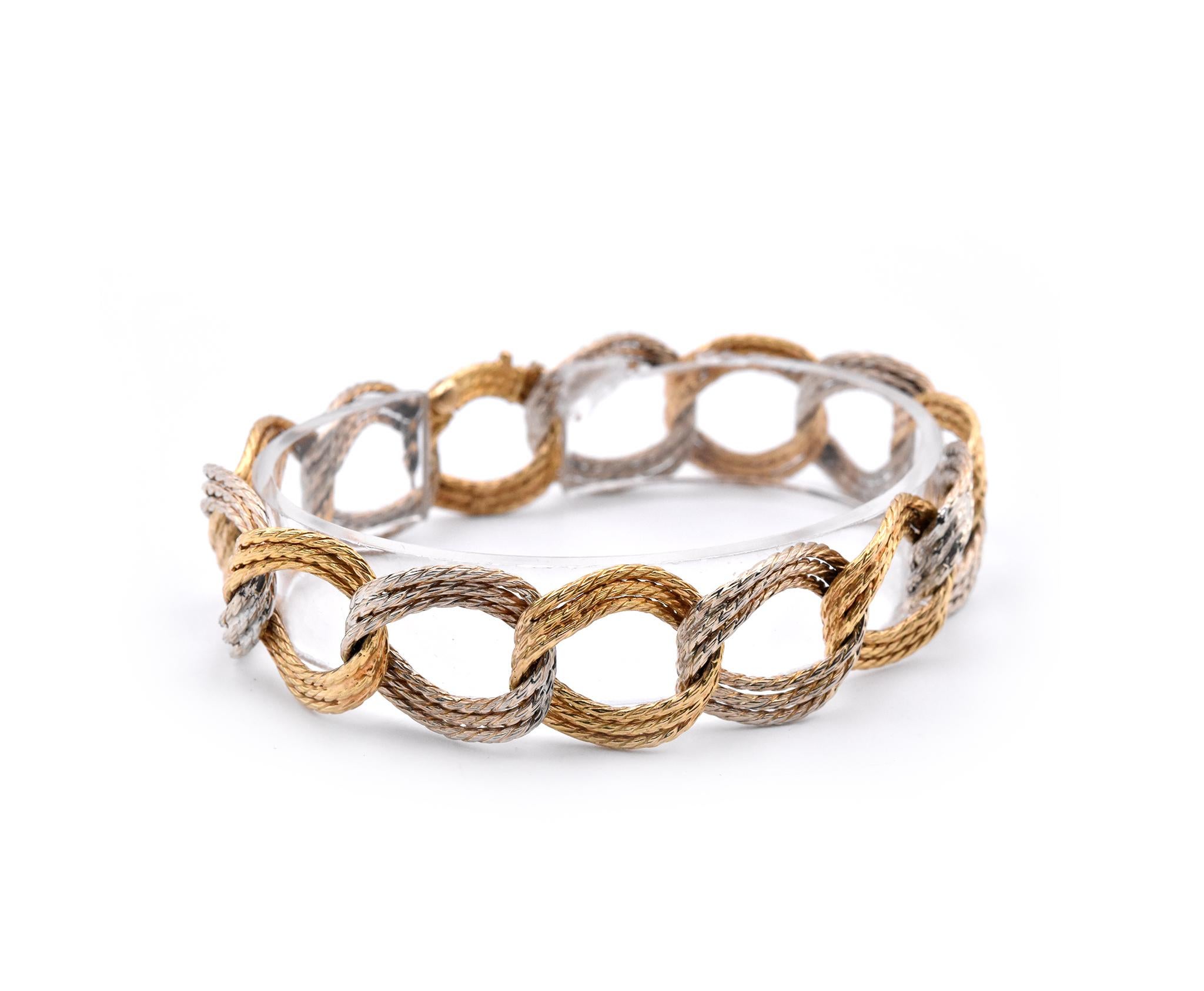 Designer: custom
Material: 18k yellow and white gold
Dimensions: bracelet measures 7.75-inches in length and 16.3mm in width
Weight: 32.2 grams
