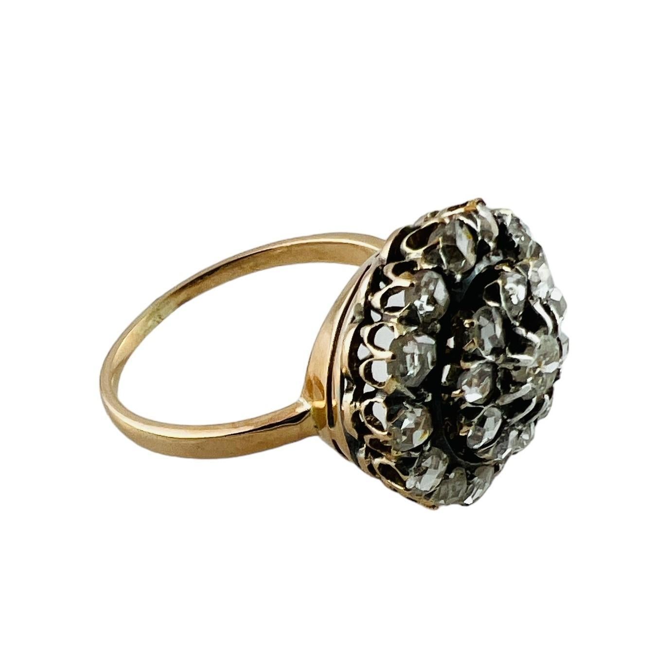 18K Yellow and White Gold Rose Cut Diamond Cluster Ring

This gorgeous diamond ring features two circular rows of 24 rose cut diamonds centered by 1 European cut diamond. 
Diamonds are set in silver which was typical of this time period. 

Center