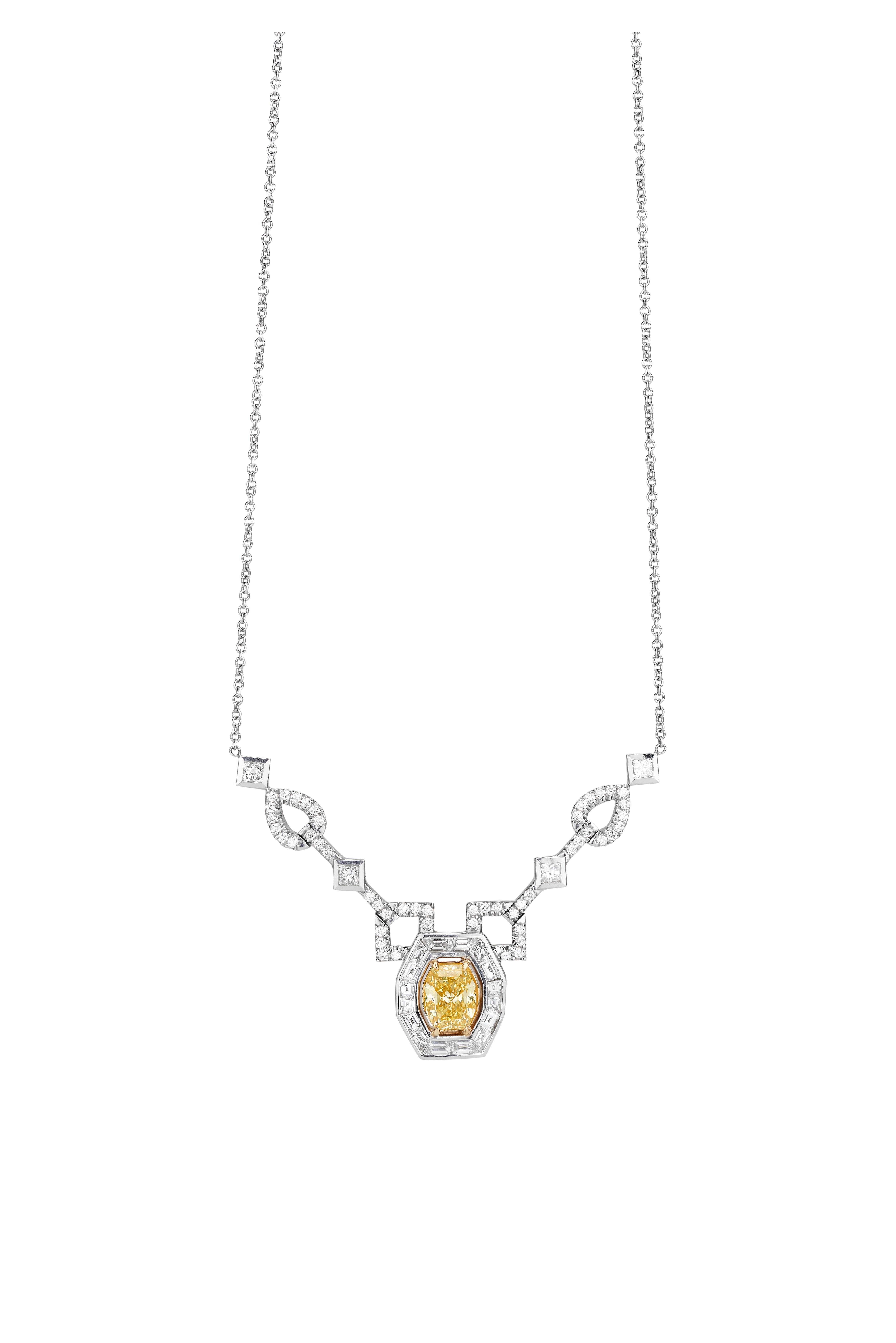 18k yellow and white gold octagonal fancy intense yellow diamond weighing 3.03ct. with 60 round diamonds weighing .81cts. and 4 princess cut diamonds weighing .60ctw. and 16 baguettes weighing 1.70ctw. The white diamonds are G-H in color and VS-SI