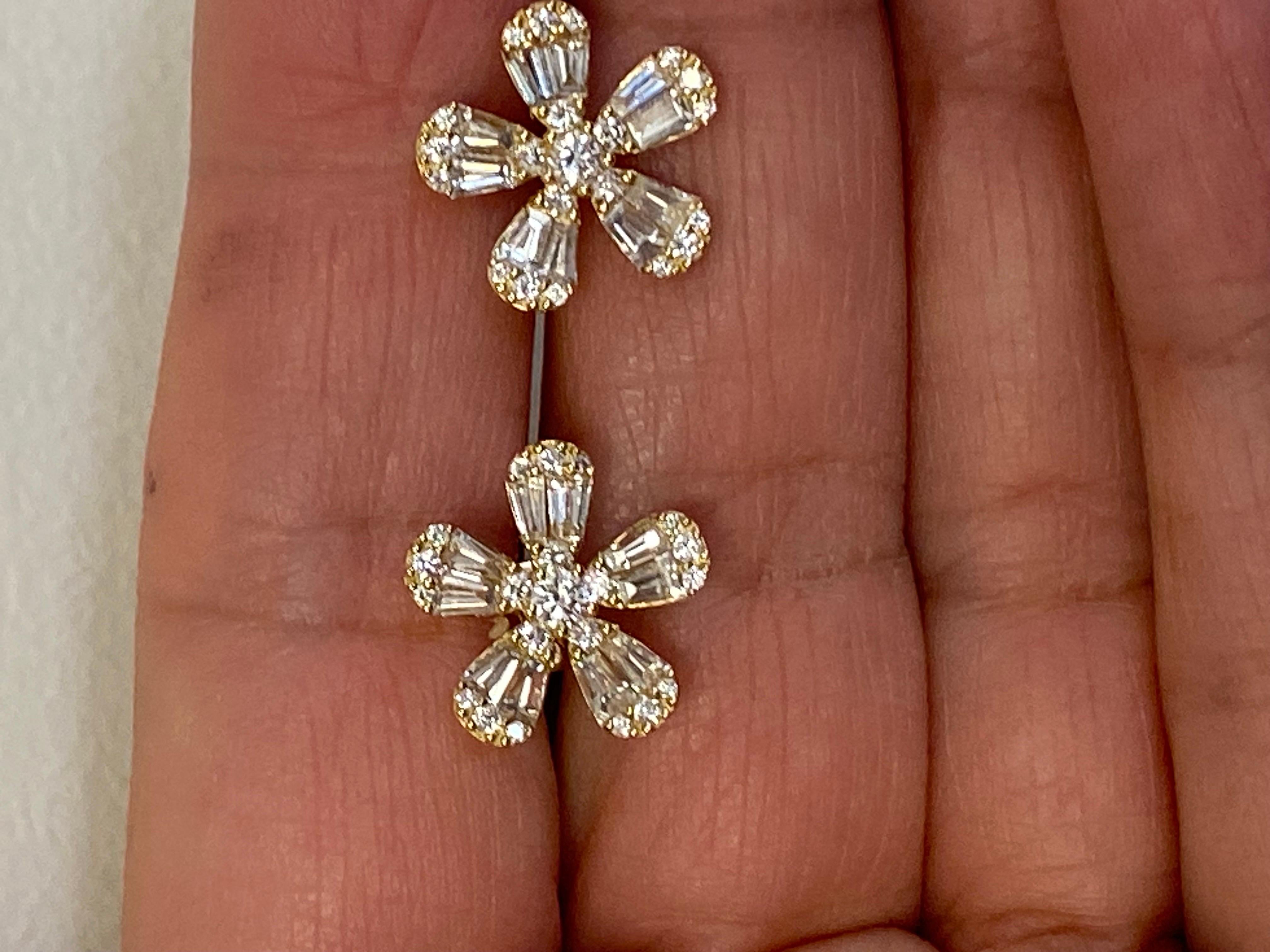 Daisy shaped yellow earrings set with baguette and round diamonds. The total weight of the earrings is 1.37 carats. The color of the stones are F, the clarity is VS1. The earrings are set in 18K yellow gold and are available in white.