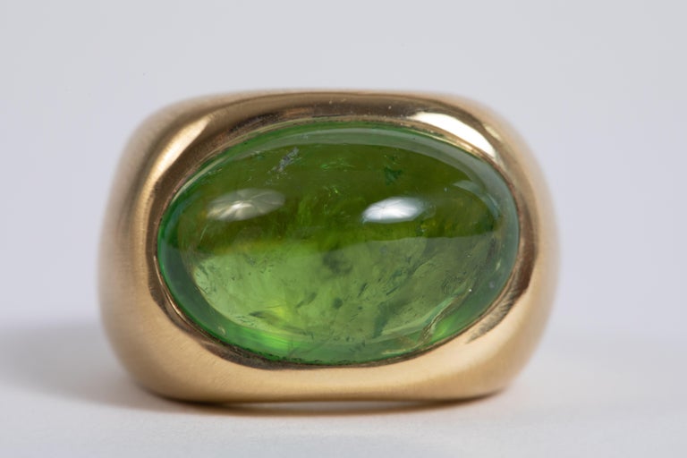 Easy to wear, a beautiful volume for a handsome green tourmaline cabochon,
18K yellow gold ring
Created by Marion Jeantet
The ring is a size 7 1/2 ( or 56) but can be sized.

Green Tourmaline cabochon's weight: 16.75 carats
Total weight: 21.31