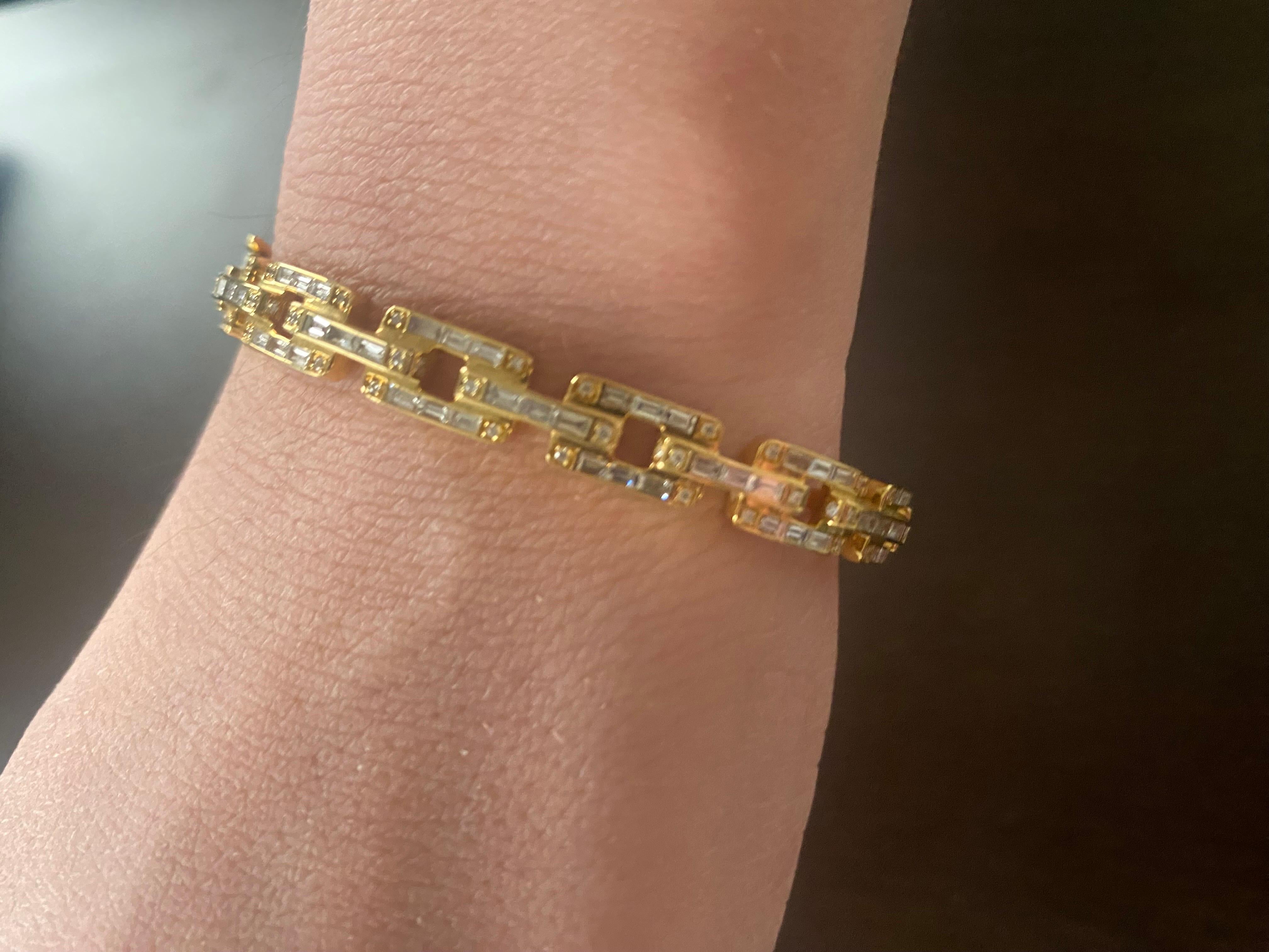Diamond bangle set halfway in 18K yellow gold. The bangle is set in a link fashion design with baguette and round diamonds. The color of the stones are F, the clarity is VS1. The carat weight is 1.86. The bangle is available in white gold. Can be
