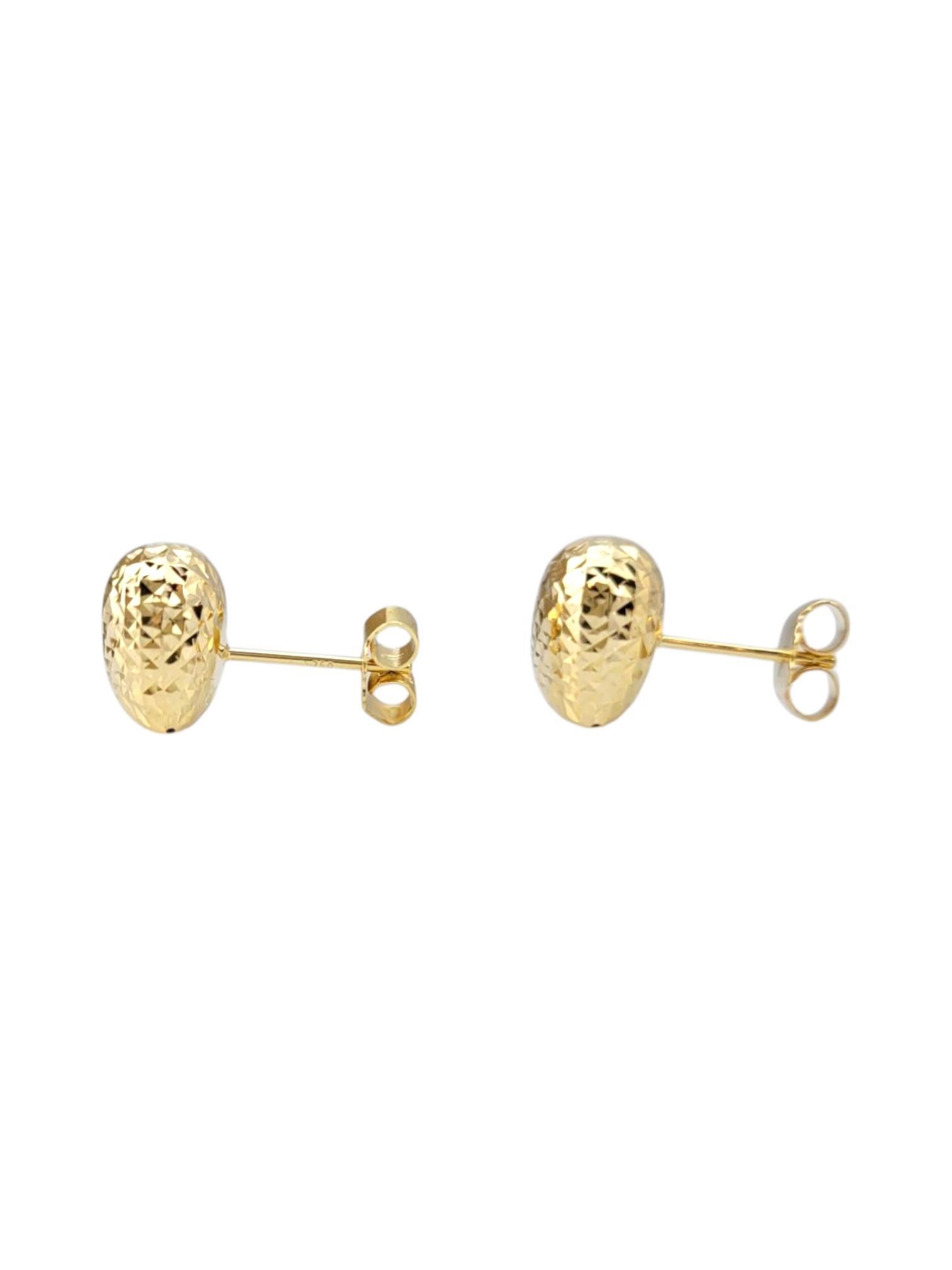 18K Yellow Gold Diamond Cut Puffy Heart Earrings -

These hammered heart earrings feature a textured finish that adds depth and dimension to the classic heart shape. Crafted for a unique, rustic charm, they offer a playful yet sophisticated touch to