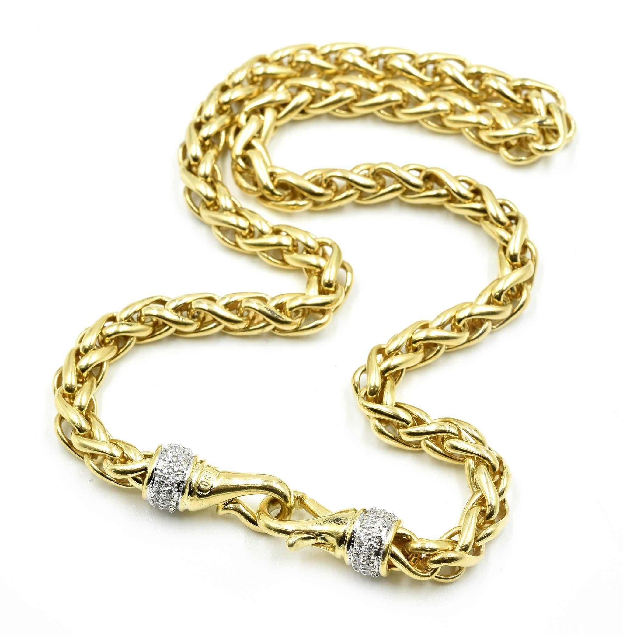 This necklace is made in 18k yellow gold with wheat style links and accentuated with dazzling diamonds on the clasp. The necklace is made with wheat style links that measure approximately 5.86mm in diameter. The necklace is 16” inches long and