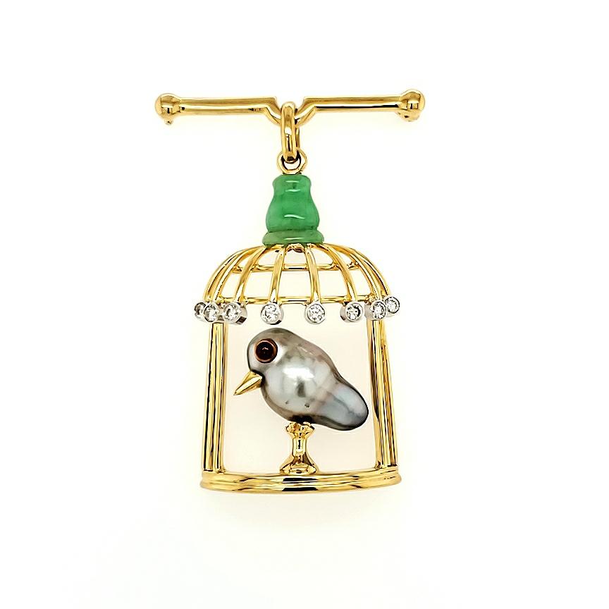 18k Yellow Gold 0.32 ctw Diamond Bird in Cage Brooch

This charming piece is a fusion of elegance and playfulness, making it the perfect addition to your collection.

The vibrant green stone delicately attached to the bars is skillfully carved from