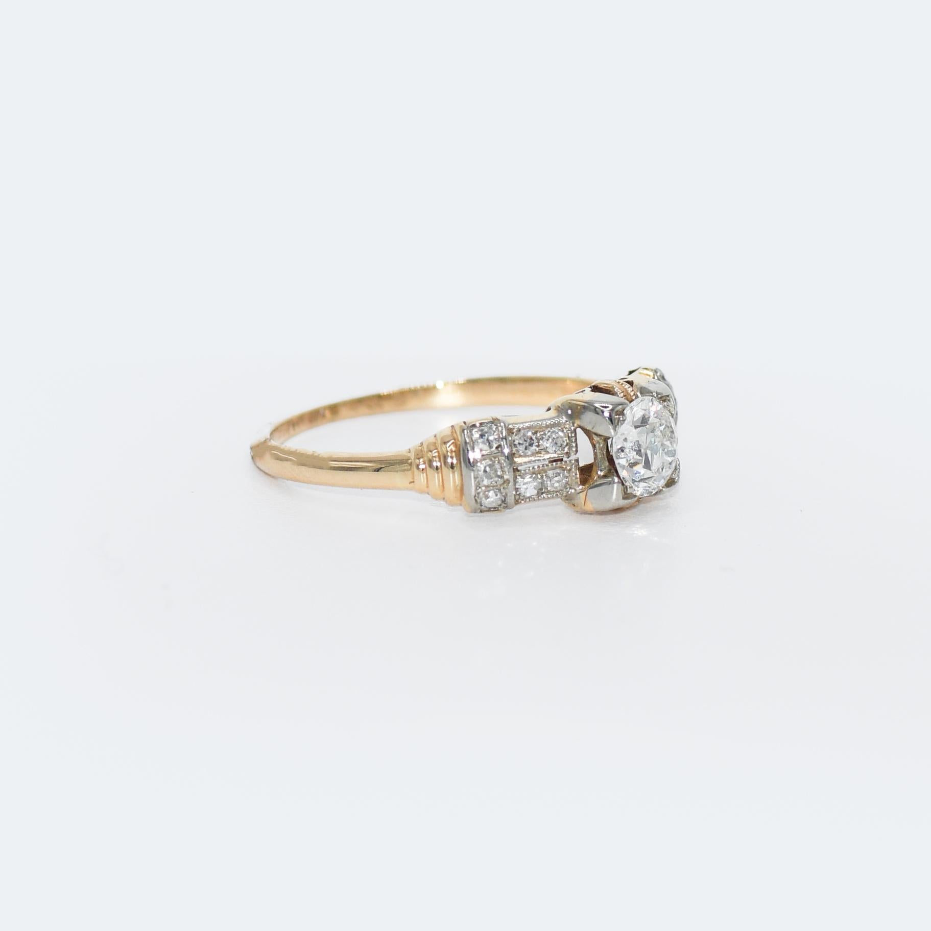 This Art Deco 18 karat yellow gold ring
Contains a solitaire old cut diamond, with a carat weight of 0.40, a VS2 clarity, and an H color.
This diamond is accented by diamonds on each side, with a carat weight of 0.14.
The ring is a size 6.5 and in