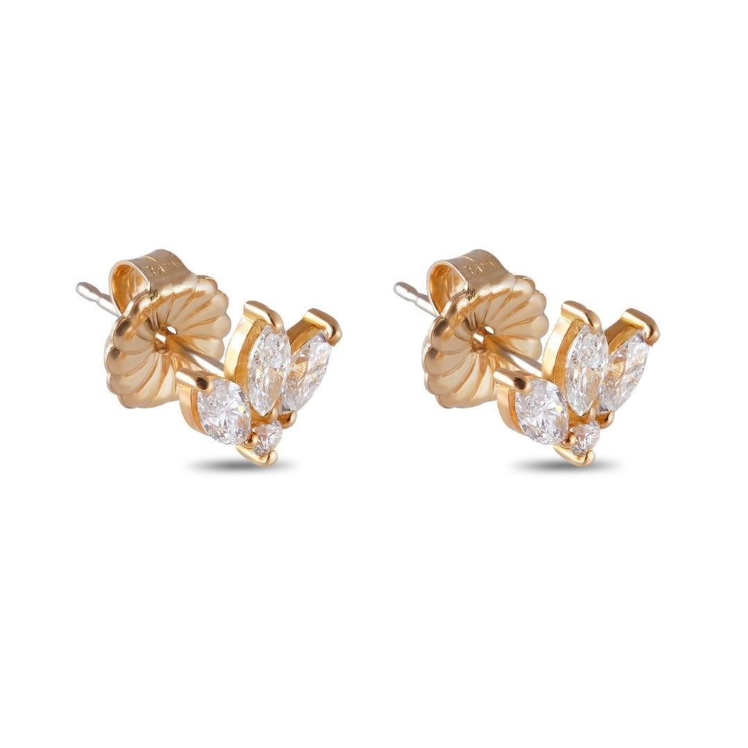 Lovely pair of 18k yellow gold and dainty 0.80 carat marquise and petit sparkling round diamond leaf studs. The marquis shape flashes bursts of light, shimmer and shine with every move, making them perfect as a second piercing stud for layering with