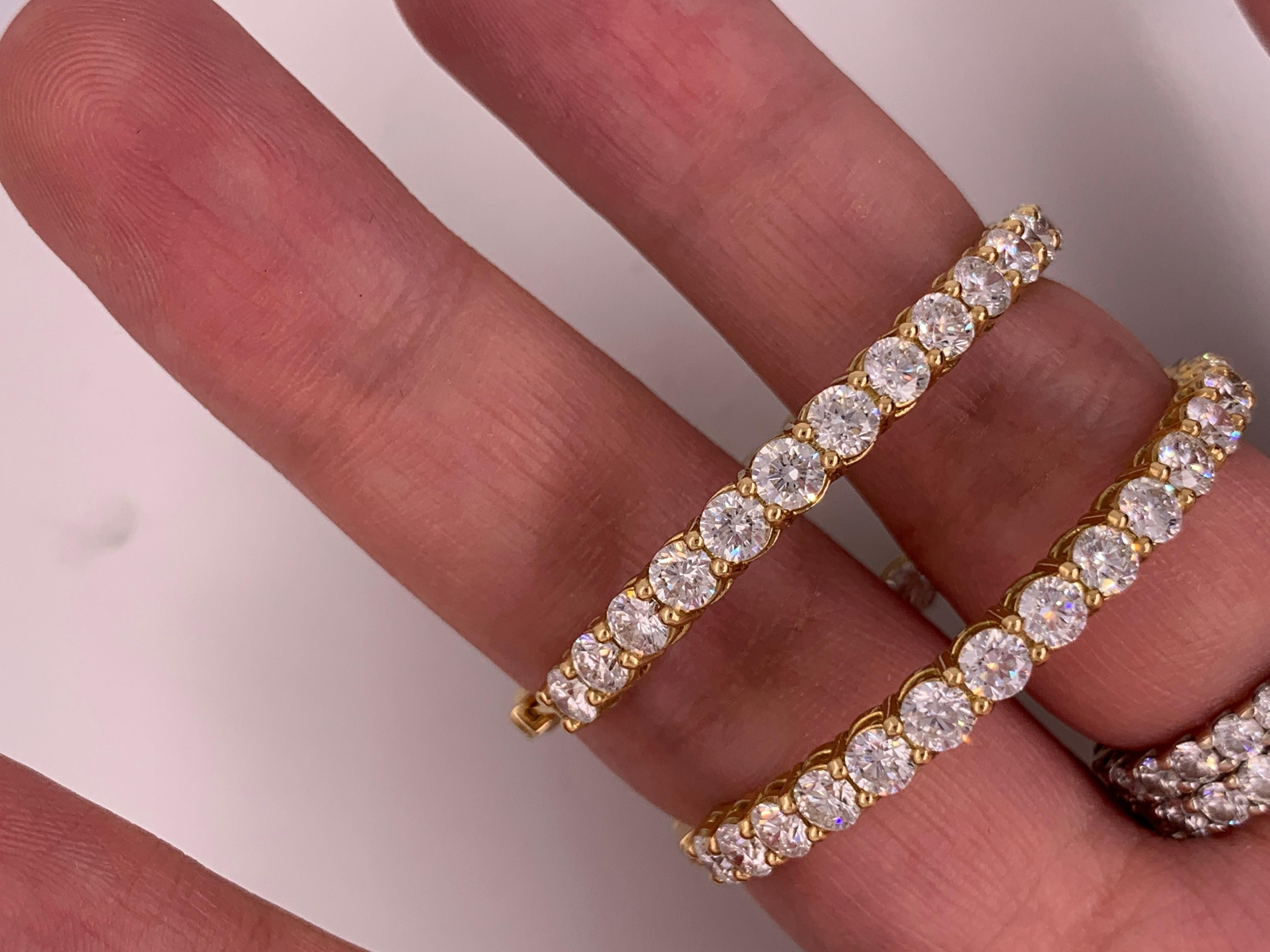 18K Yellow gold diamond hoop earrings features 10.30 Carats of diamonds, each diamond approximately 0.17 carats 1.75