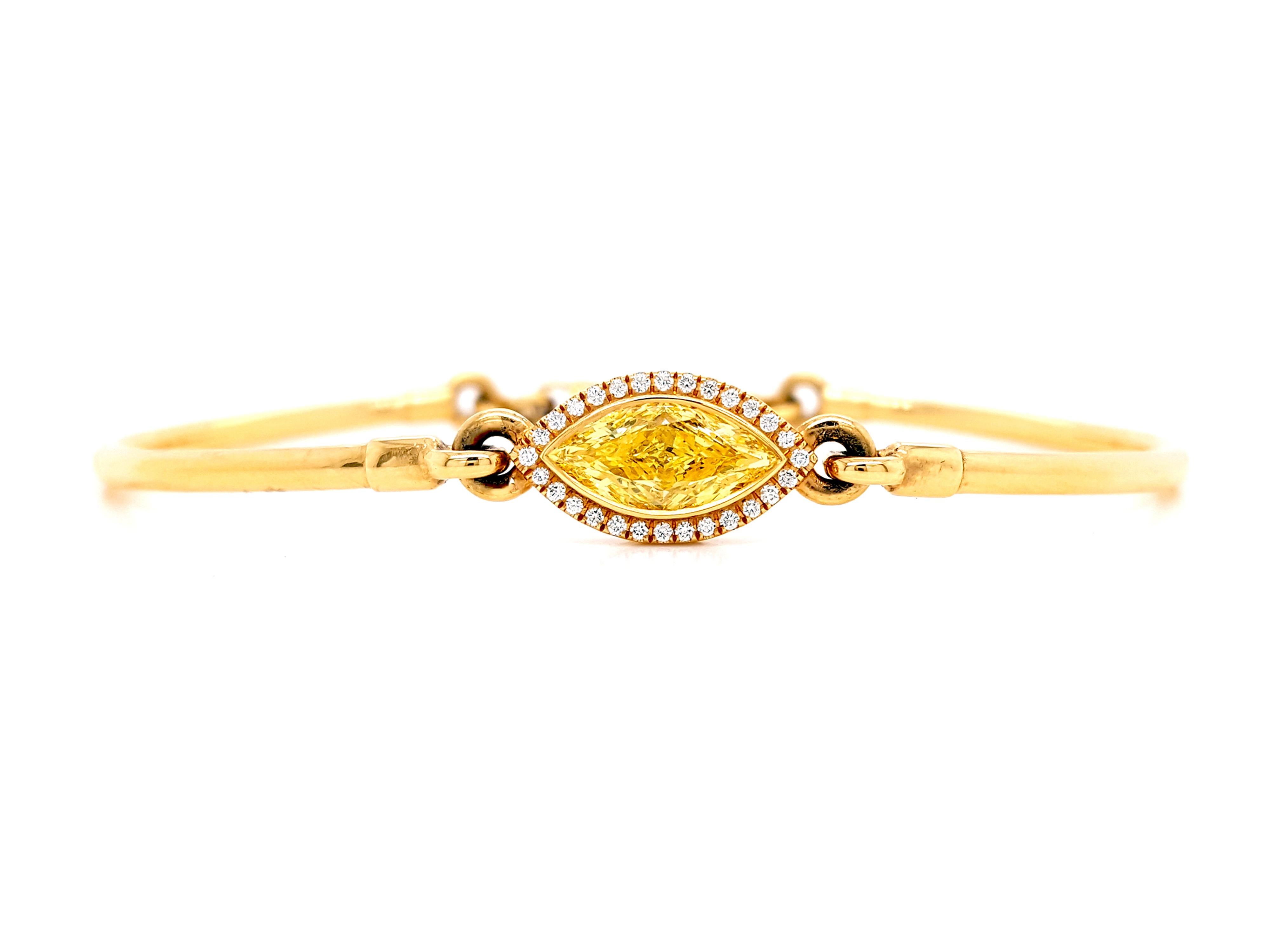An elegant 1.25 carat total weight Fancy Intense Yellow Diamond bangle. This gorgeous 18 karat yellow gold diamond bangle has 1.13 carat Fancy Intense Yellow, Marquis-cut Diamond, GIA certified as VS2 clarity in the center, surrounded by a single