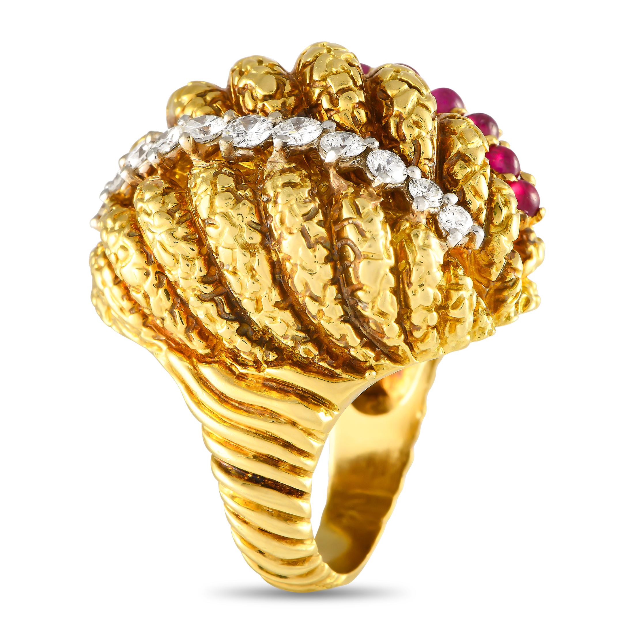An intricately designed cocktail ring whose very presence demands attention. This 18K yellow gold beauty features a tapering ridged band that widens towards the oversized domed top. The eye-catching centerpiece features a row of diamonds and a row