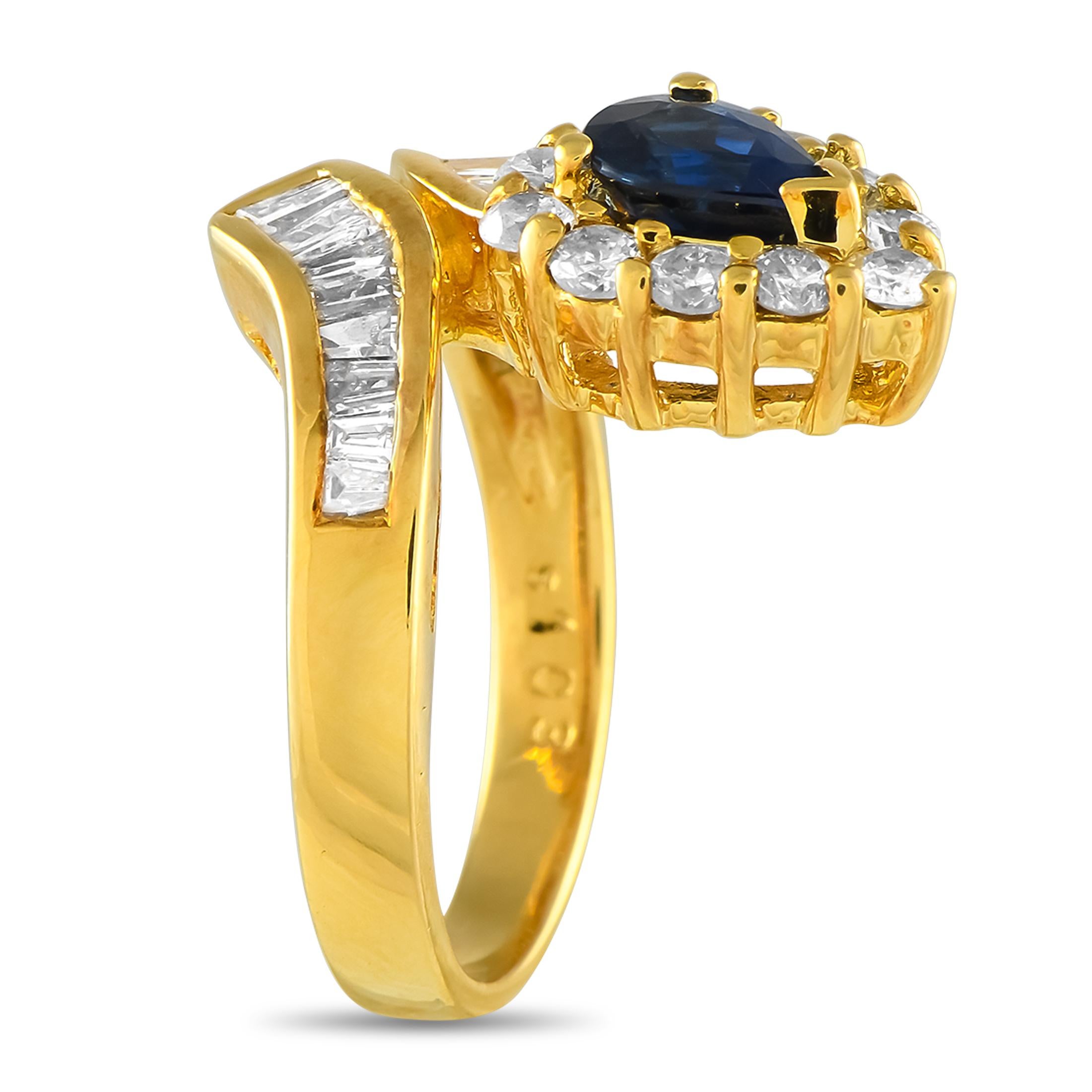 A stylish 18K Yellow Gold setting makes this ring looks like it wraps around the finger. A 1.03 carat Sapphire center stone makes a statement, while sparkling Diamonds totaling 1.31 carats further elevate this impressive accessory. This timeless