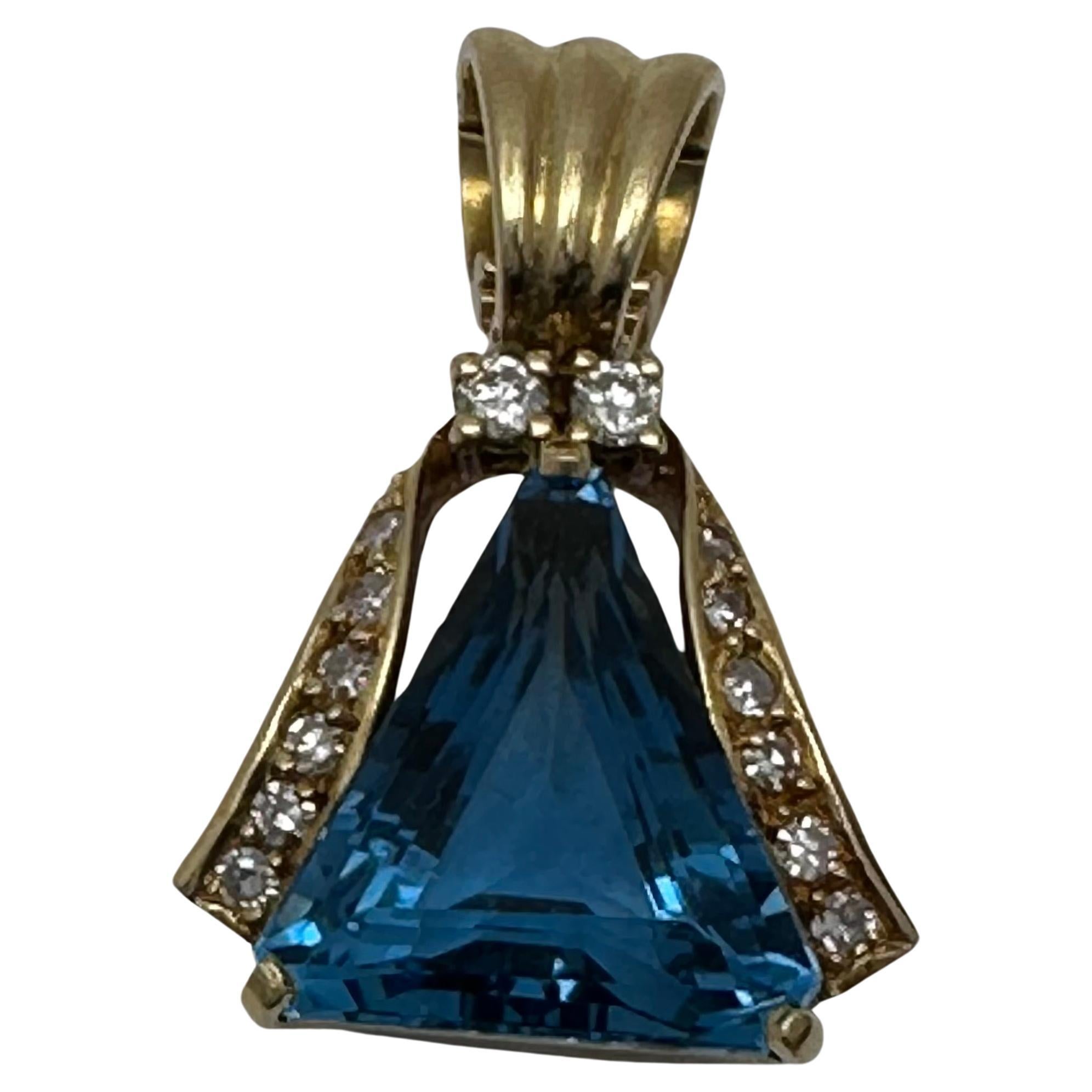 18k Yellow Gold 13mm x 15mm Triangular London Blue Topaz with 14 Diamonds / Pendant / Enhancer
Measurement are approx.

Blue Topaz Meaning:

This vivacious blue gemstone is known as the stone of clarity. The Blue Topaz meaning allows you to channel