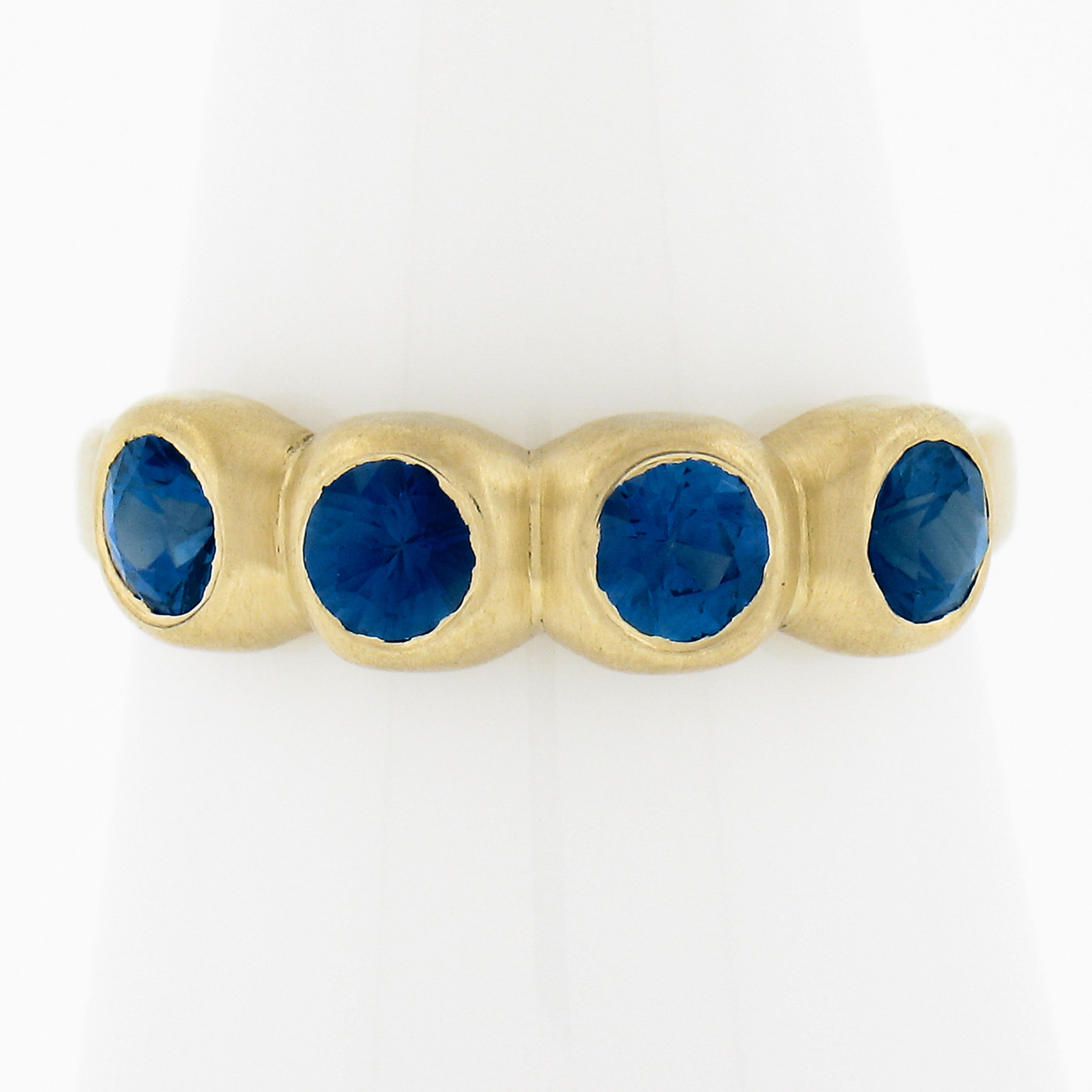 --Stone(s):--
(4) Natural Genuine Sapphires - Round Brilliant Cut - Bezel Set - Lively Bright Brilliant Blue Color 
Total Carat Weight:	1.20-1.40 (approx.)

Material: Solid 18K Yellow Gold
Weight: 3.85 Grams
Ring Size: 7.5 (Fitted on a finger. We