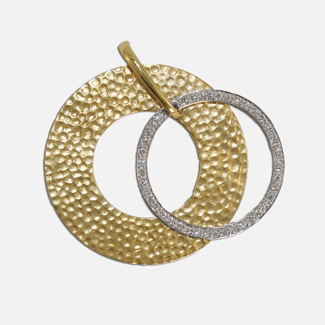 18k yellow gold and 14k white gold diamond circle pendant.
The large yellow gold piece is stamped 18k, 750, and tests 74% gold with an XRF analyzer.
The white gold test is between 54% to 56% gold.
The diamonds are round brilliant cuts, .40 total