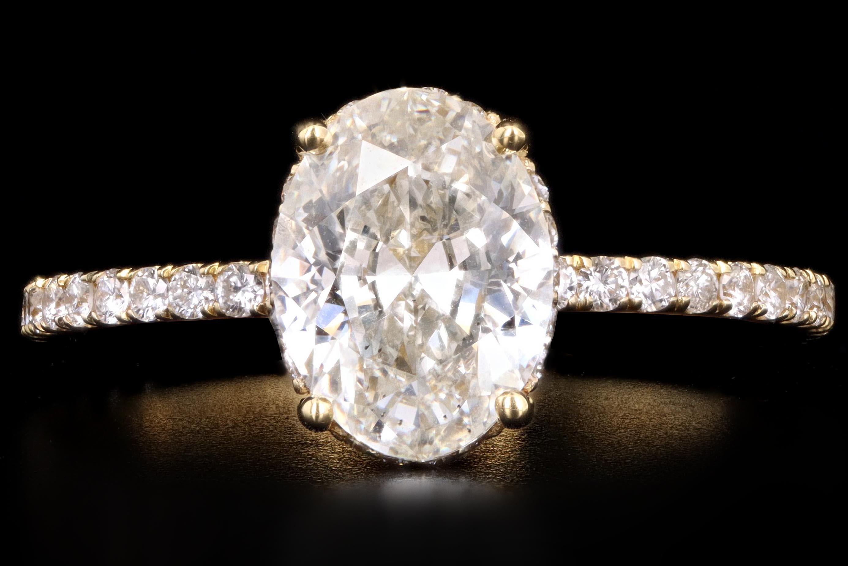 Era: New

Composition: 18K Yellow Gold

Primary Stone: Oval Cut Diamond

Carat Weight: 1.50 Carats

Color: J

Clarity: SI2

Accent Stones: 50 Round Brilliant Cut Diamonds

Carat Weight: .35 Carats

Color: G-H

Clarity: Vs1/2

Total Carat Weight: