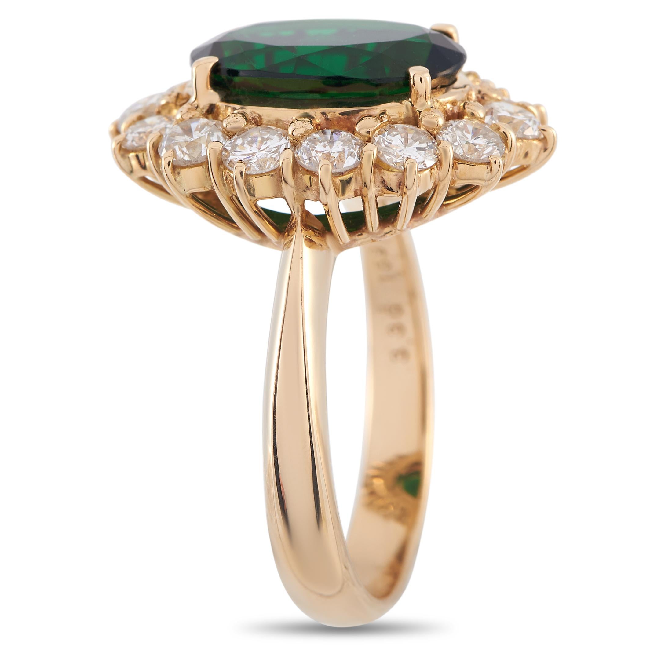 A beautiful estate ring with an undeniable vintage charm. This piece in 18K yellow gold features a polished band that gently narrows as it approaches the centerpiece. At its heart is a vivid and rich green tourmaline stone surrounded by an