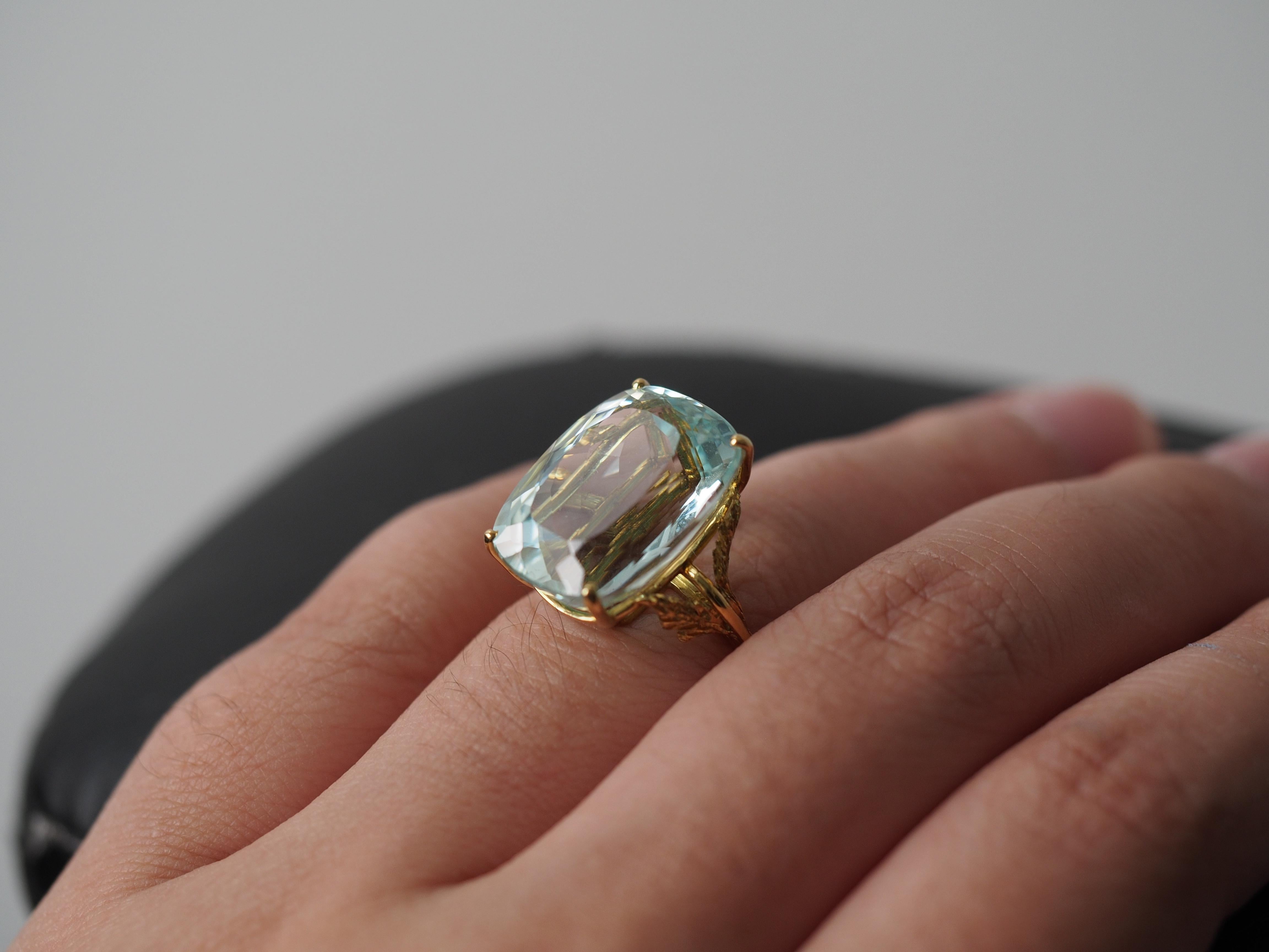 Year: 1960s

Item Details:
Ring Size: 7
Metal Type: 18k Yellow Gold [Hallmarked, and Tested]
Weight: 7.67 grams

Aquamarine Details:

GIA Report Number:1226950692

Natural Aquamarine, Green-Blue Color, Cushion Shape

17.00ct Approximate