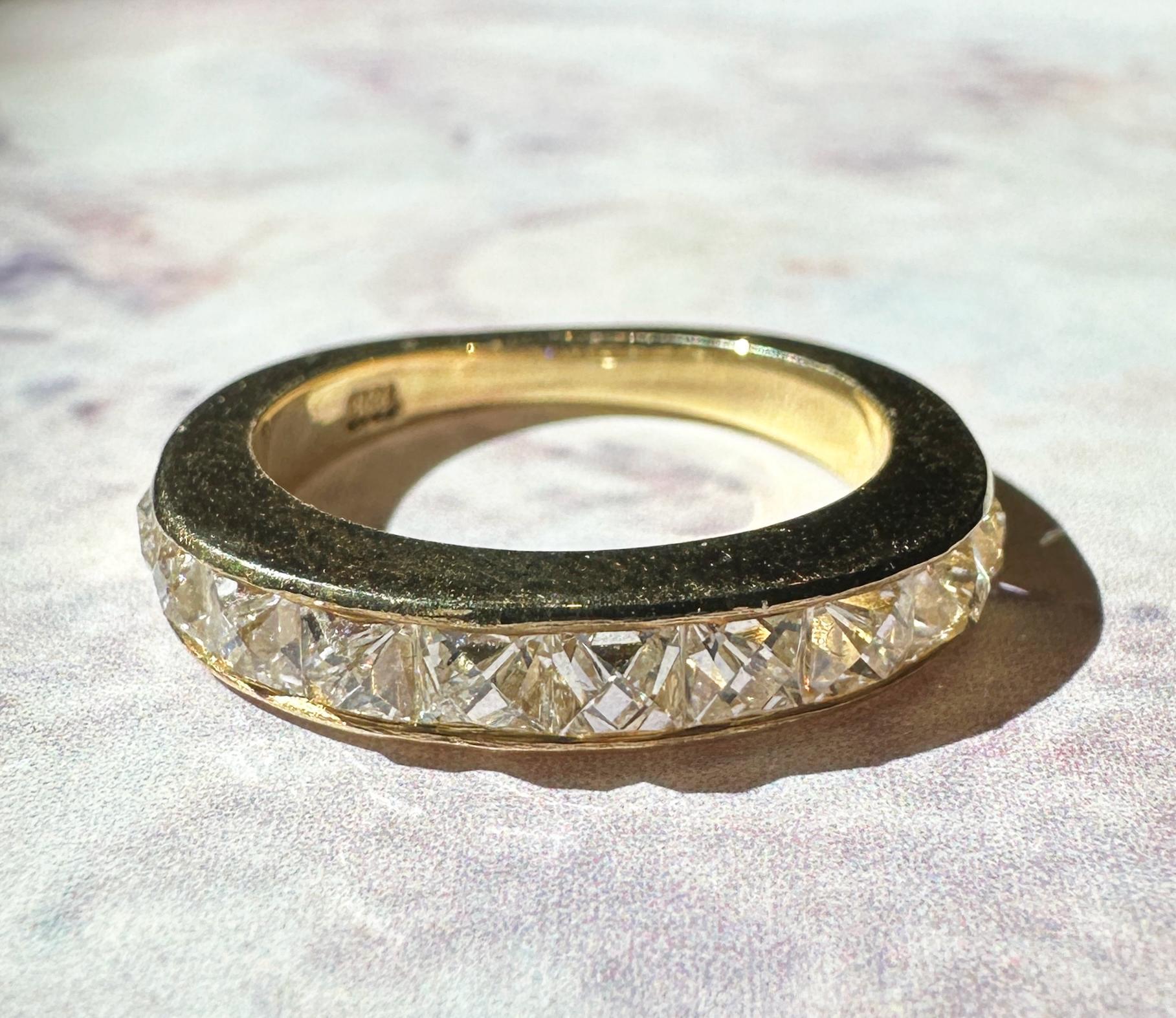 Indulge in our 18k Yellow Gold Repurposed French Cut Diamond Band. Expertly crafted from repurposed french cut diamonds and on 18k yellow gold, these rings are both sustainable and stunning. The diamonds weigh 1.84 carats in total and weighs 4.30