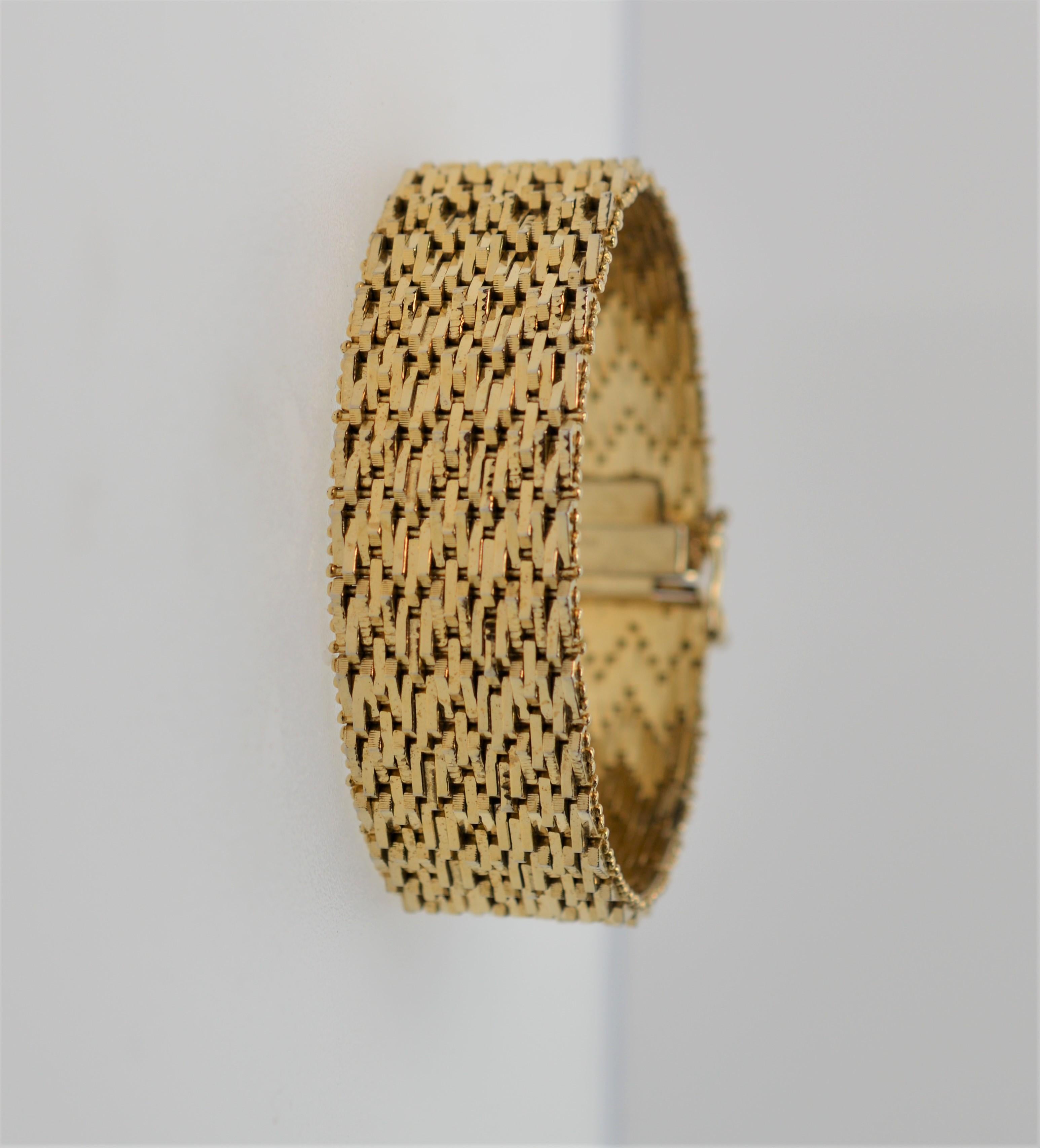 18K Yellow Gold Italian Late 1950's Retro Style Flexible Cuff Bracelet. Measures 7-3/8 inch long by 3/4 inch wide. Substantial unisex piece created with multiple small fluid woven links that give this piece its depth and flexibility. Has catch clasp