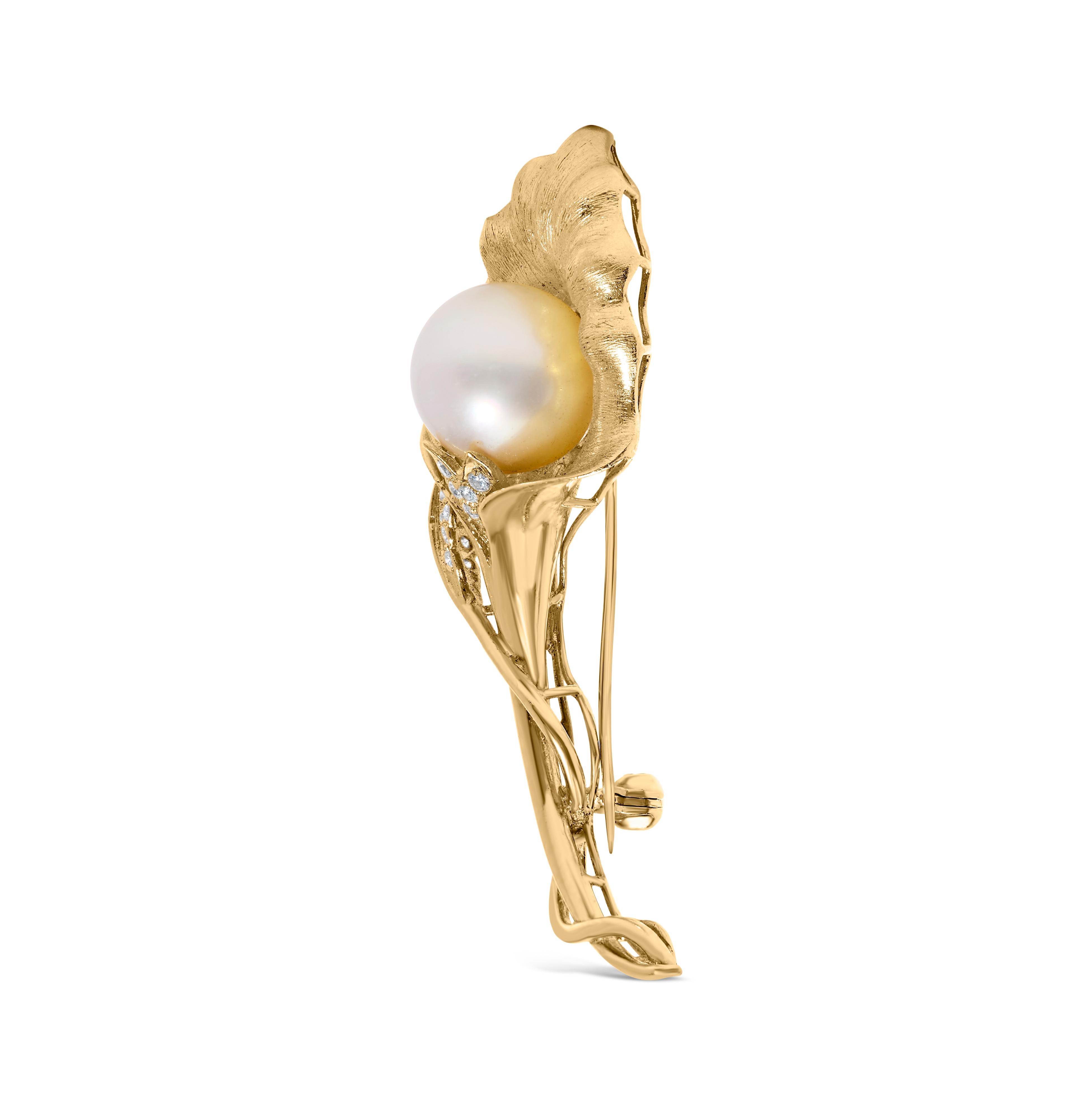 Experience the epitome of elegance with this stunning 18K yellow gold brooch, where the artistry of hammered gold is brought to life in an enchanting flower and leaf motif. At its heart lies a luminous 12MM cultured South Sea pearl, its white sheen