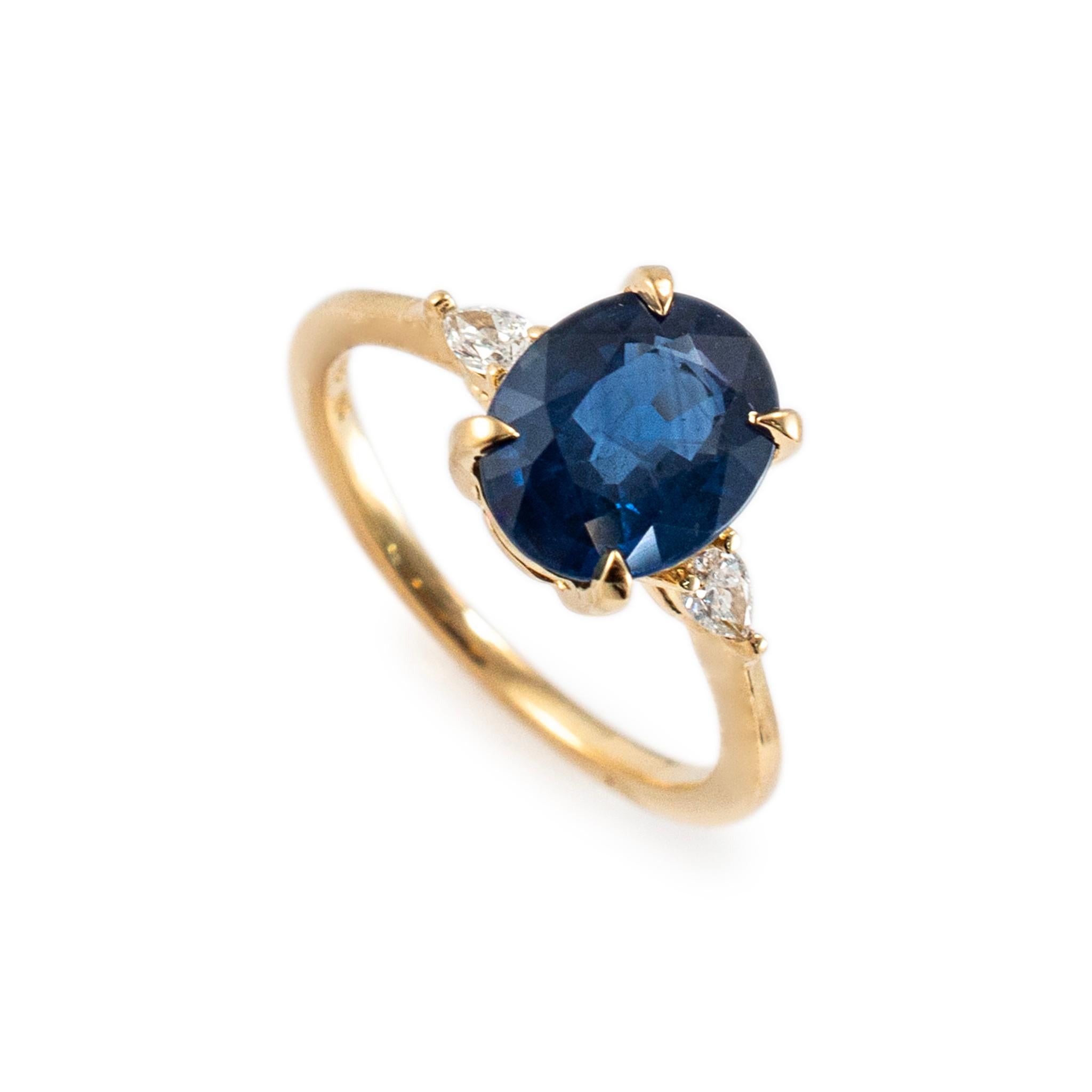 Gender: Ladies

Metal Type: 18K yellow gold

Ring Size: 5

Width: 5.90 mm

Weight: 2.94 grams

18K Yellow Gold diamond and sapphire three-stone cocktail ring with a half round shank. The metal was tested and determined to be 18K yellow gold.