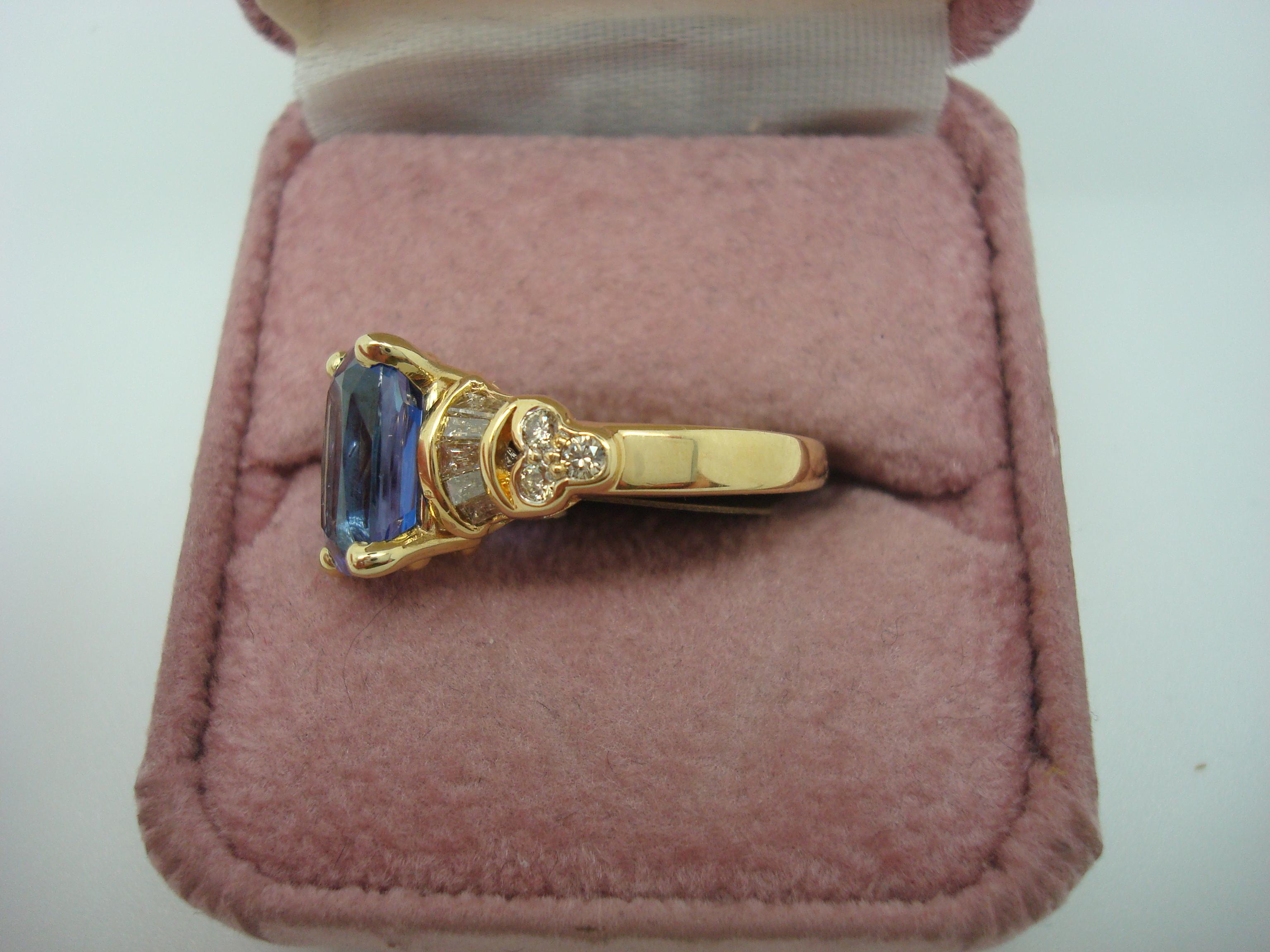 18k Yellow Gold 2.59ct Genuine Natural Tanzanite and Diamond Ring (#J1811)

Very fine 18k yellow gold ring featuring an excellent 2.59 carat tanzanite. The tanzanite is a medium-dark color in a modified oval brilliant cut, and it measures