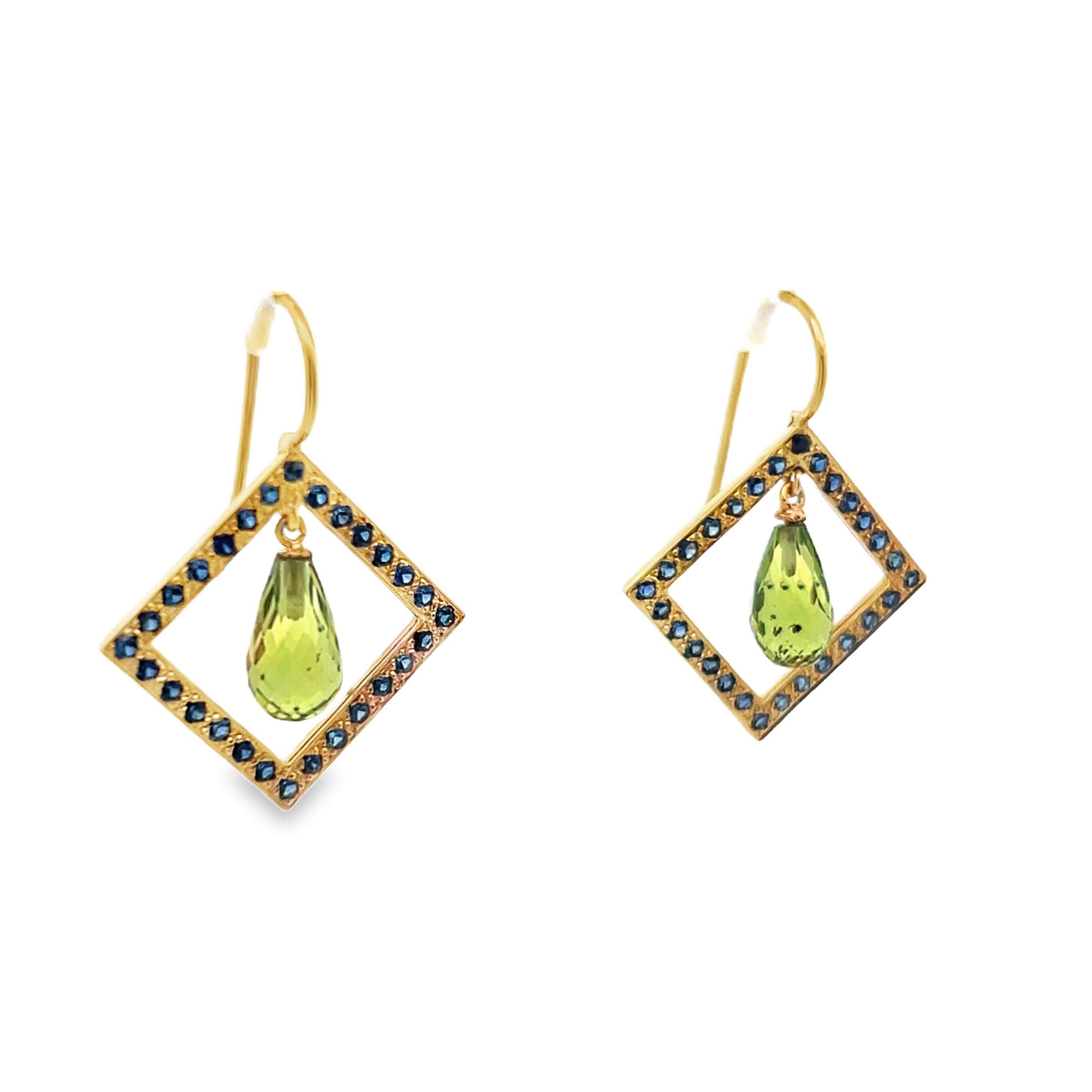 This is a fantastic pair of dop earrings made in 18k yellow gold with both peridot and blue sapphire. The unique square geometric frame is lined with bright blue sapphires and displays a gorgeous peridot in the center that dangles and moves with the