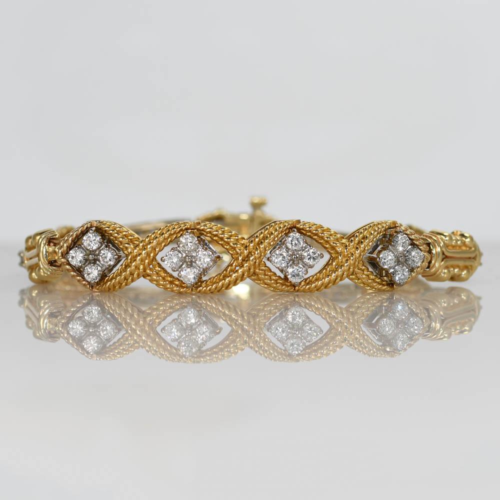 Ladies designer diamond bracelet in 18k yellow and white gold.
Stamped 18k, Jabel and weighs 23.9 grams.
Fancy metal work.
The diamonds are round brilliant cuts, 1.00 total carats, G to H color, Vs to Si clarity.
The bracelet measures 6 3/4 inches