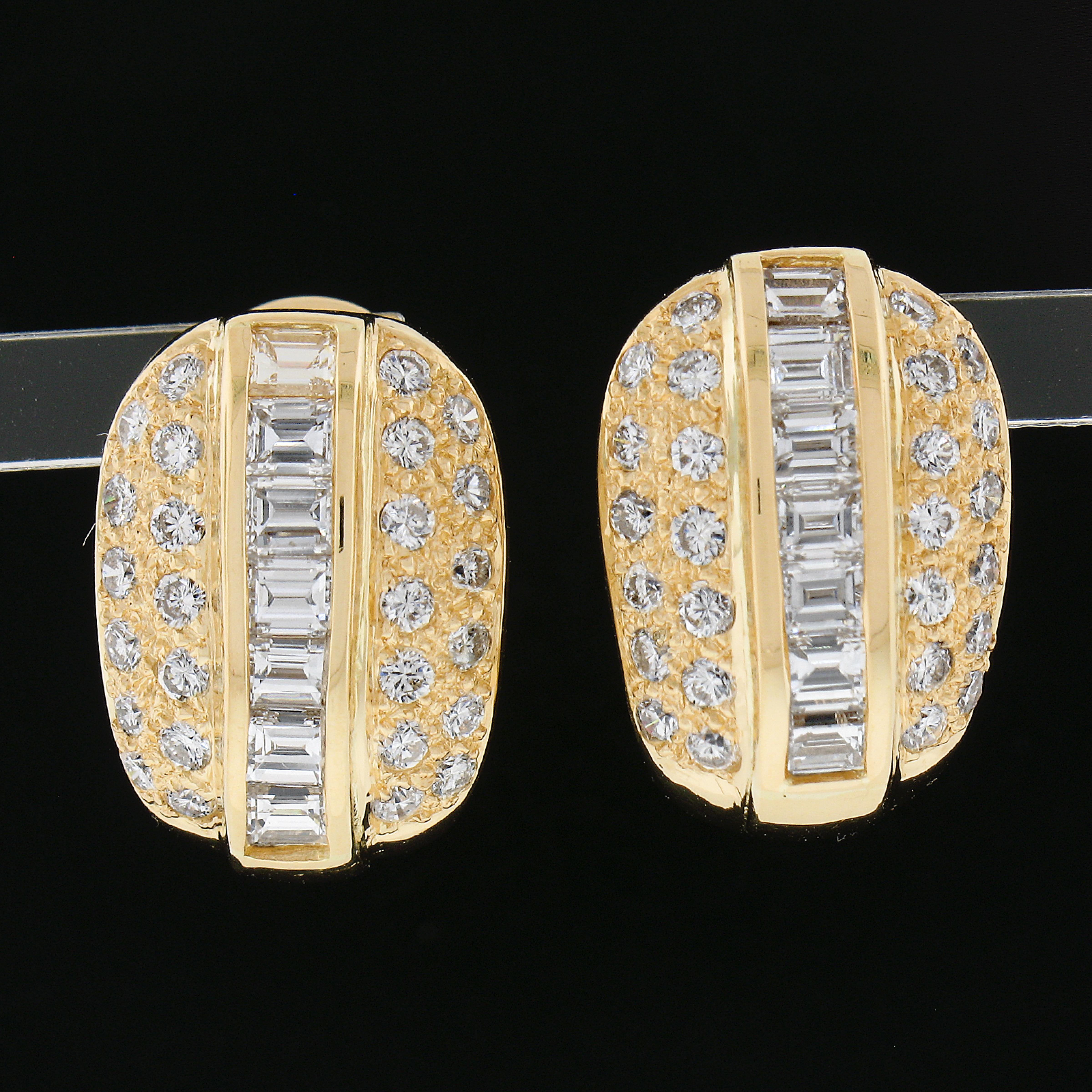 You are looking at a beautiful pair of earrings crafted in solid 18k yellow gold. These earrings feature approximately 2.3ctw of diamonds. The center row are rectangular step cut diamonds in a channel settings and accented with round brilliant cut