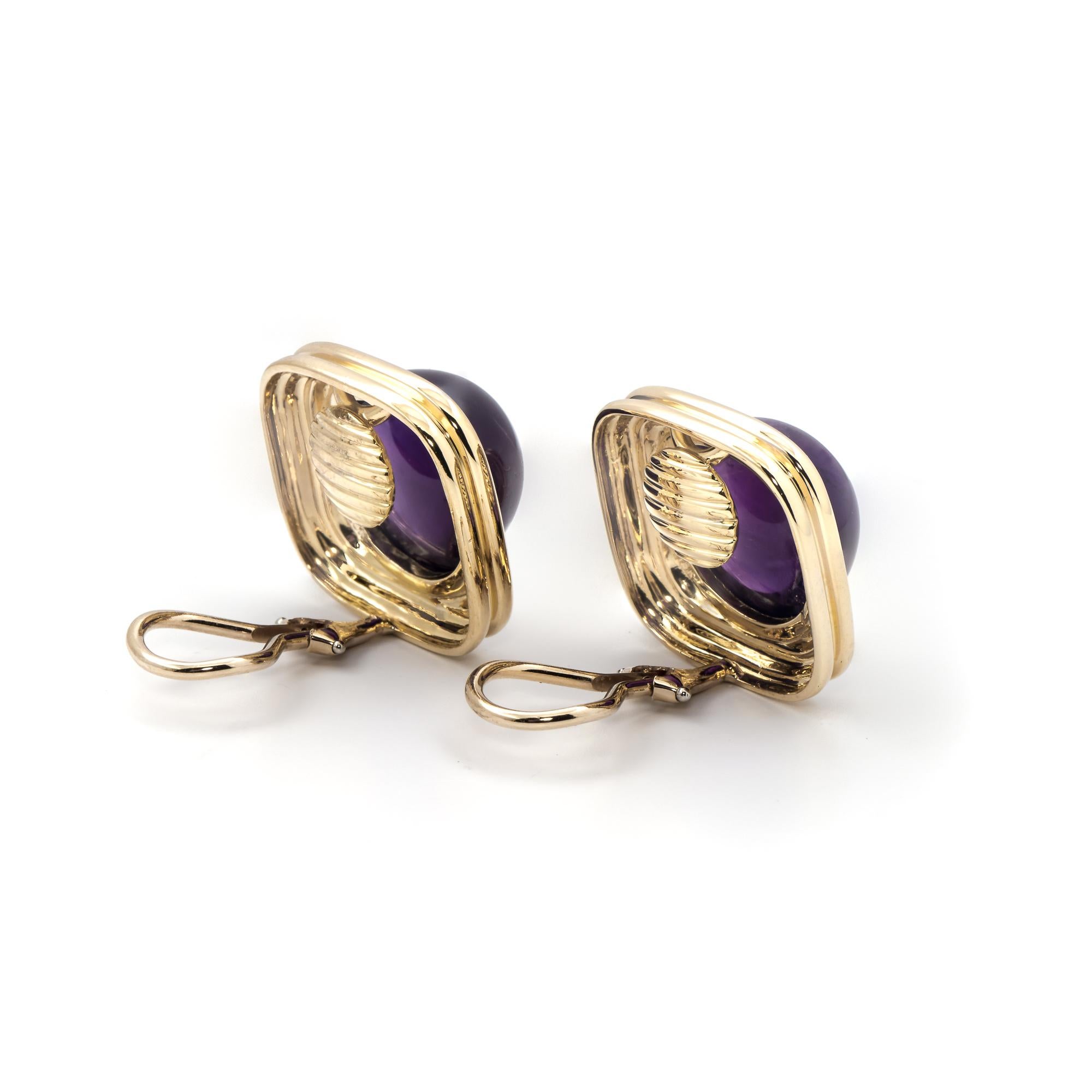 Exclusively from our Estate collection, these 18K yellow gold clip on earrings have two round cabochon cut amethysts at 30.00ctw set in a square frame. With a classic design and a rich hue of purple; these earrings are a wonderful gift for the