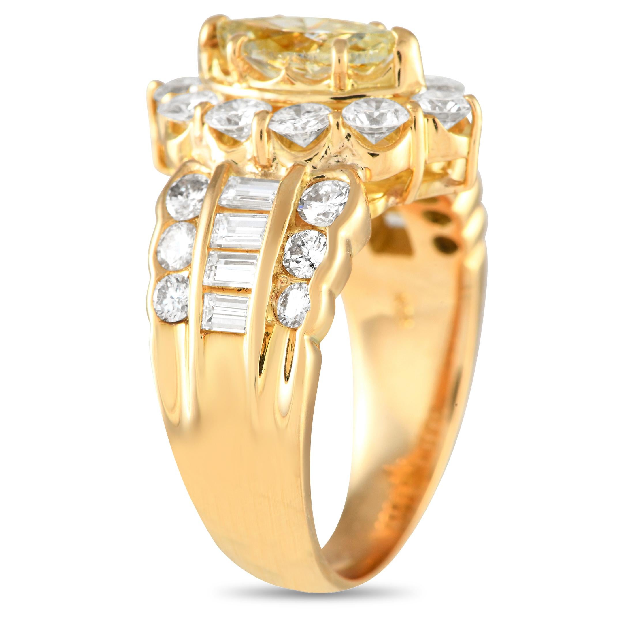 A powerfully elegant ring that can take any outfit to glamorous heights. This piece is fashioned in 18K yellow gold, with scalloped shoulders that lead to a haloed marquise diamond centerstone. The band's shoulders feature a short channel of
