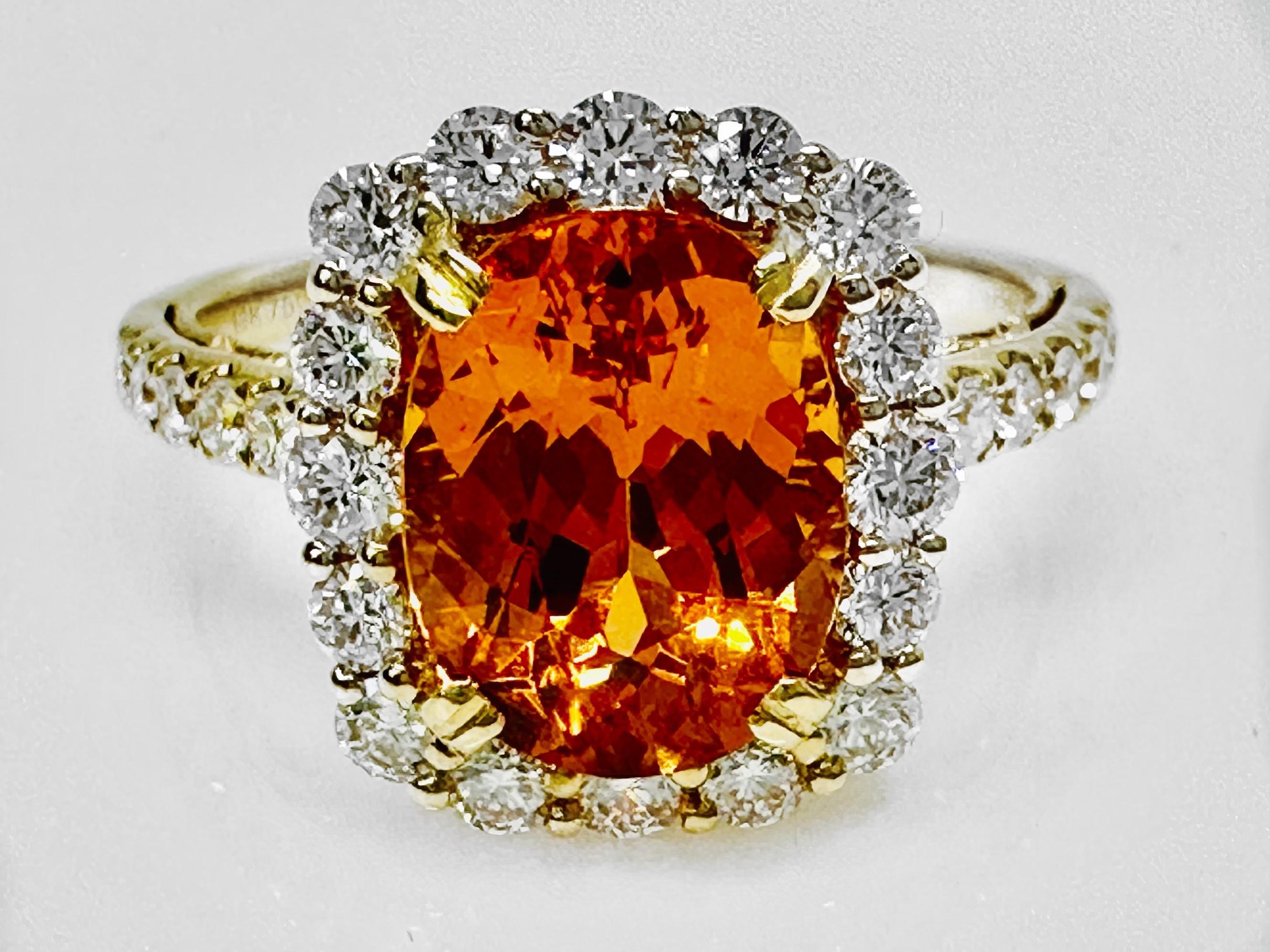 Can you say JUICY?! This gorgeous one-of-kind ring is made from 18K yellow gold, highlighting an amazing oval cut, highly saturated, 3.21 carat Spessartite surrounded by 28 round brilliant diamonds. It looks so good you could eat it! 

Spessartite