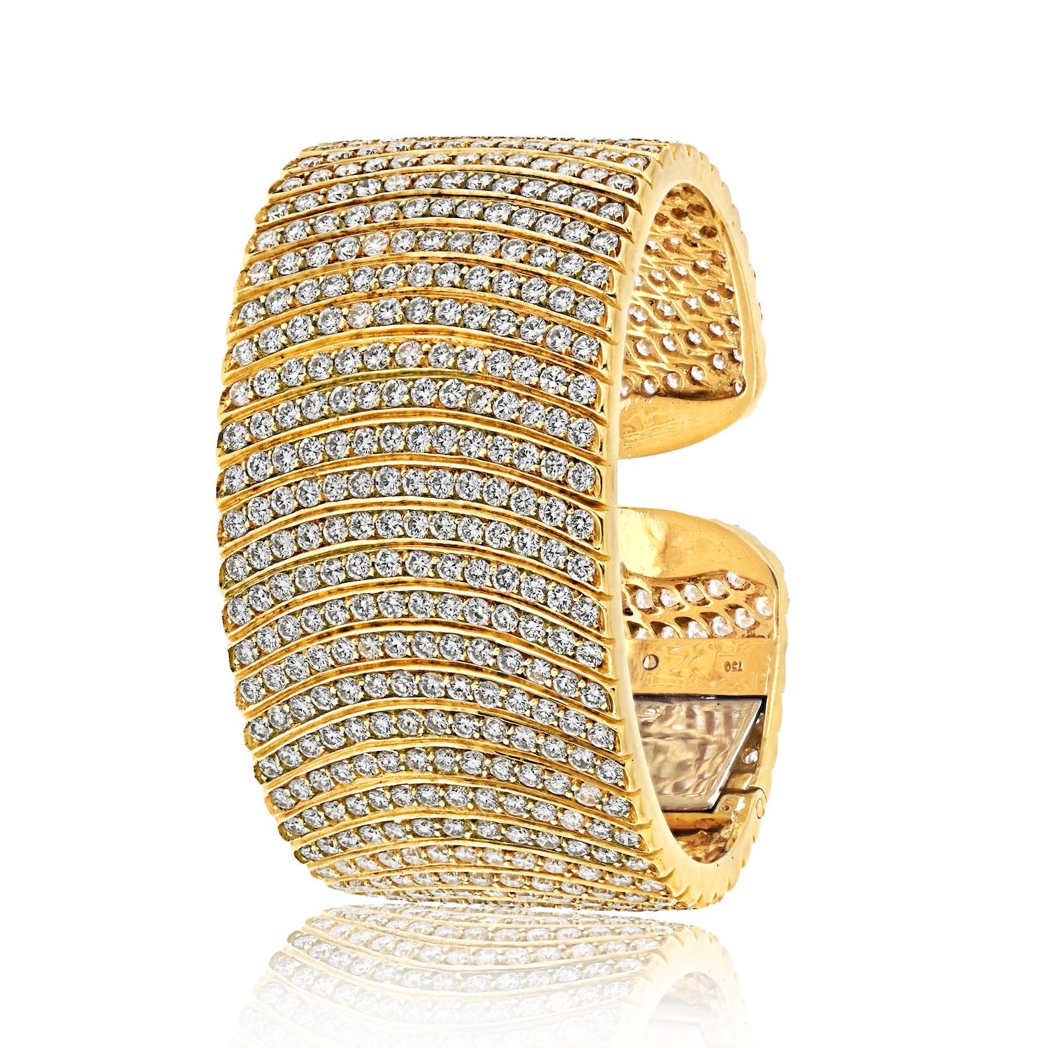 Indulge in the splendor of this exquisite diamond cuff bracelet, meticulously crafted in 18k yellow gold and adorned with an opulent array of round brilliant cut diamonds totaling an impressive 32 carats. As you unveil this breathtaking piece,