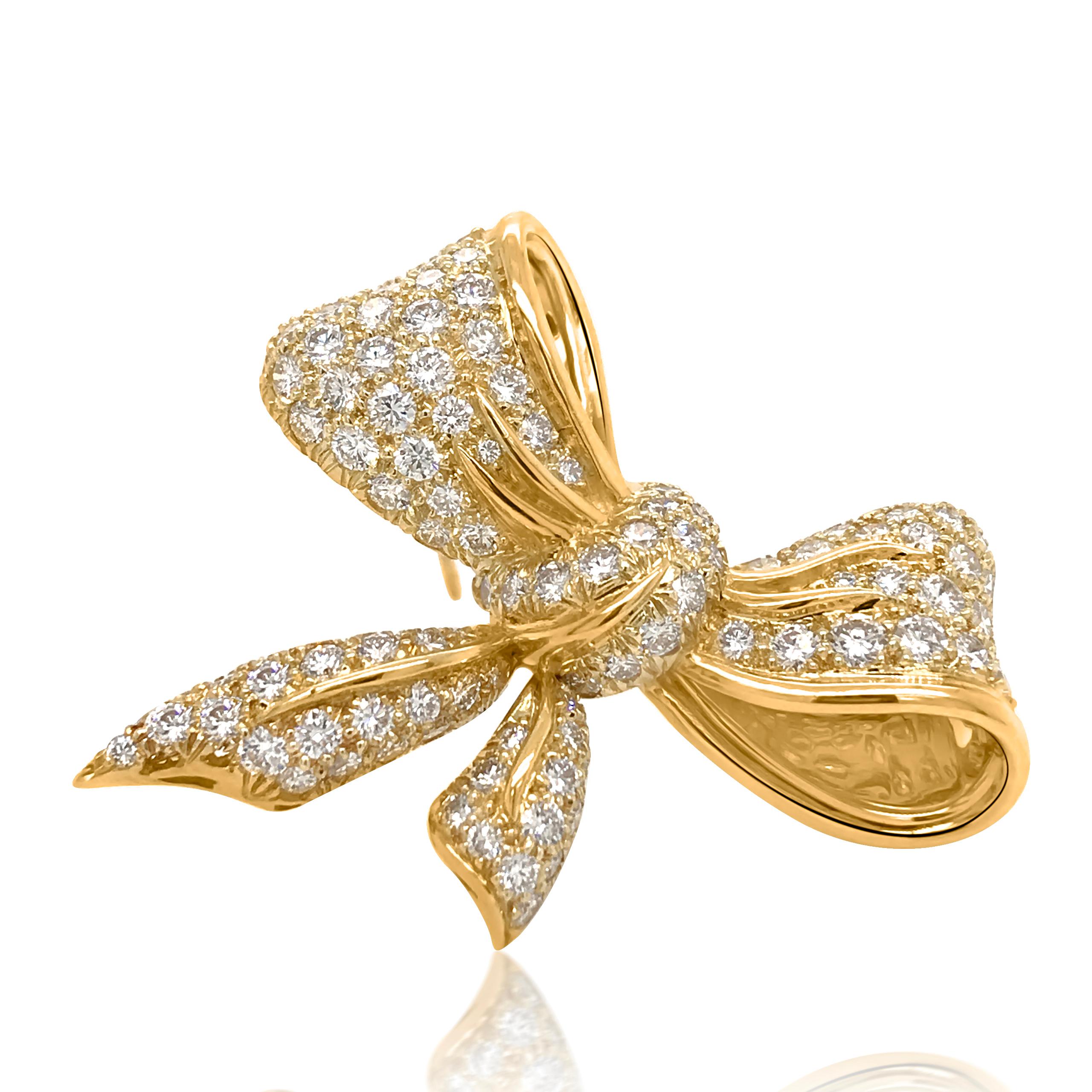 This stunning vintage diamond bow brooch is crafted in solid 18K yellow gold. Features a bow of round-cut diamonds cumulatively weighing approx. 3.75 carats, G-H color, VS clarity. This shimmering pin brooch weighs 14.57 grams and measures