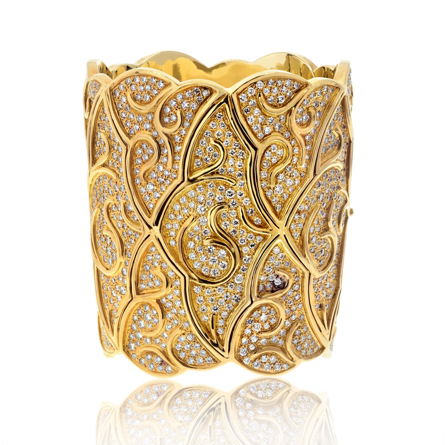 Introducing a statement piece of unparalleled elegance: This wide estate 18K Yellow Gold Tapered Cuff Bangle. Measuring an impressive 3 inches in width, this exquisite bangle features a sophisticated scroll pattern design that exudes timeless