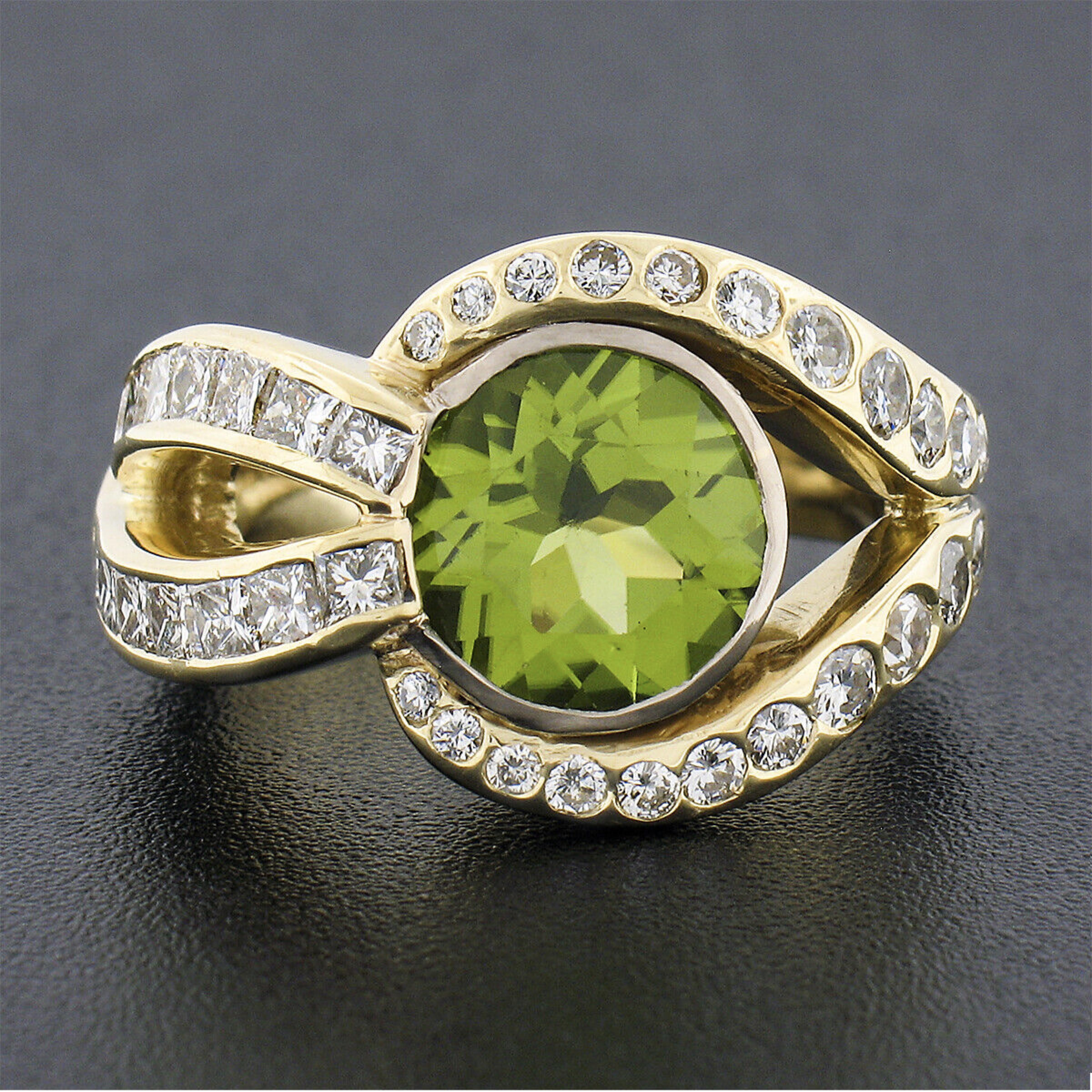 This outstanding and very well made peridot and diamond cocktail ring is crafted in solid 18k yellow gold and features a truly elegant, open, overlapping design set with a very fine quality peridot solitaire and fiery diamond accents throughout. The