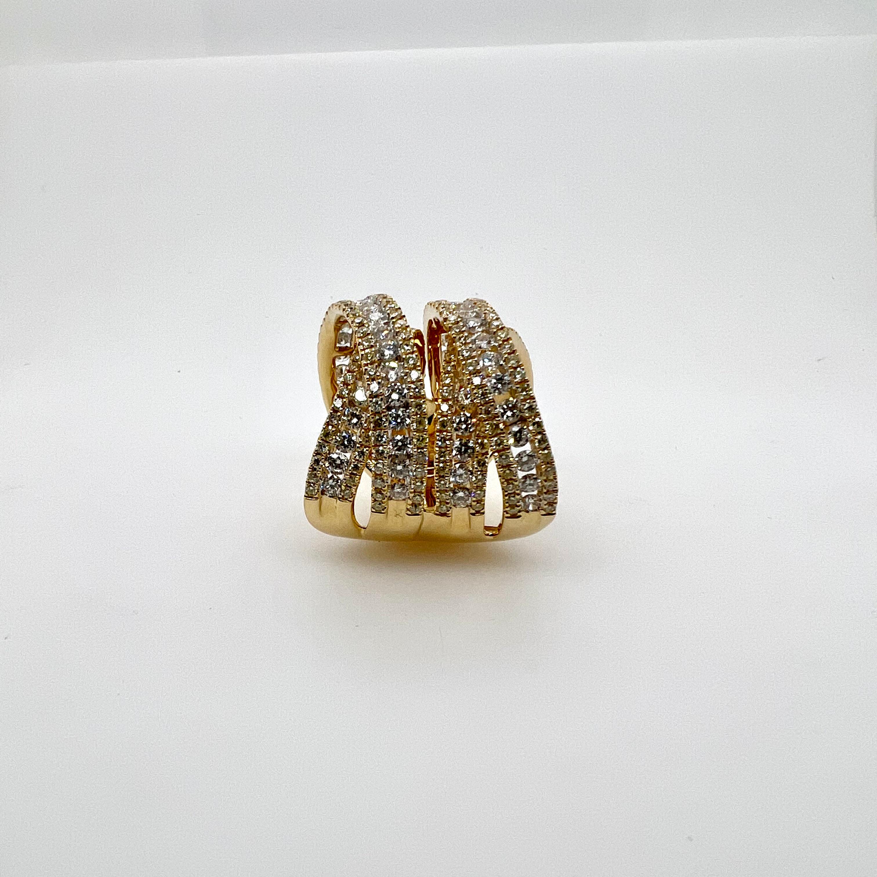 An amazing 4 row, wide diamond band made in 18k yellow gold that will surely gains everyone's attention!  This bold design has two overlapping motifs that surely accentuates the contemporary design!  The beautiful profile shows the two height levels