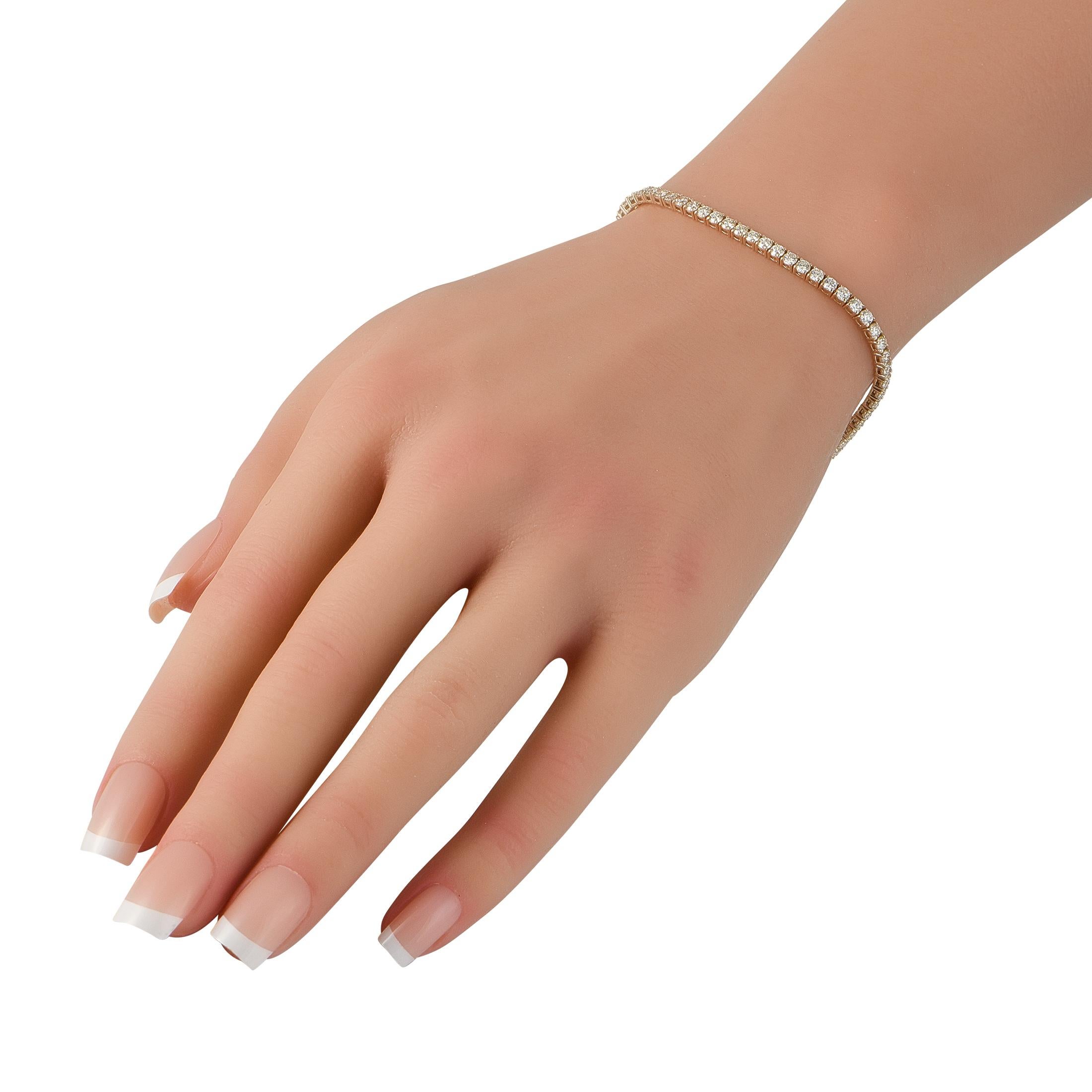 This luxurious tennis bracelet is stylish and sophisticated. Crafted from 18K Yellow Gold, the minimalist design beautifully showcases a series of sparkling Diamonds totaling 4.13 carats. It measures 7.5 long and will instantly add a touch of