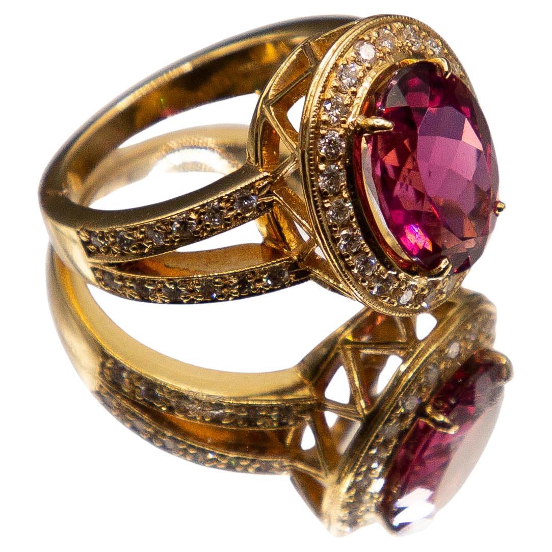 A virtually flawless, violetish- pink 4.59 carat oval tourmaline radiates a highly transparent, evenly distributed, dark vibrant coloration owing to exact German cutting standards. The lustrous 18 karat yellow gold handcrafted ring is encrusted with