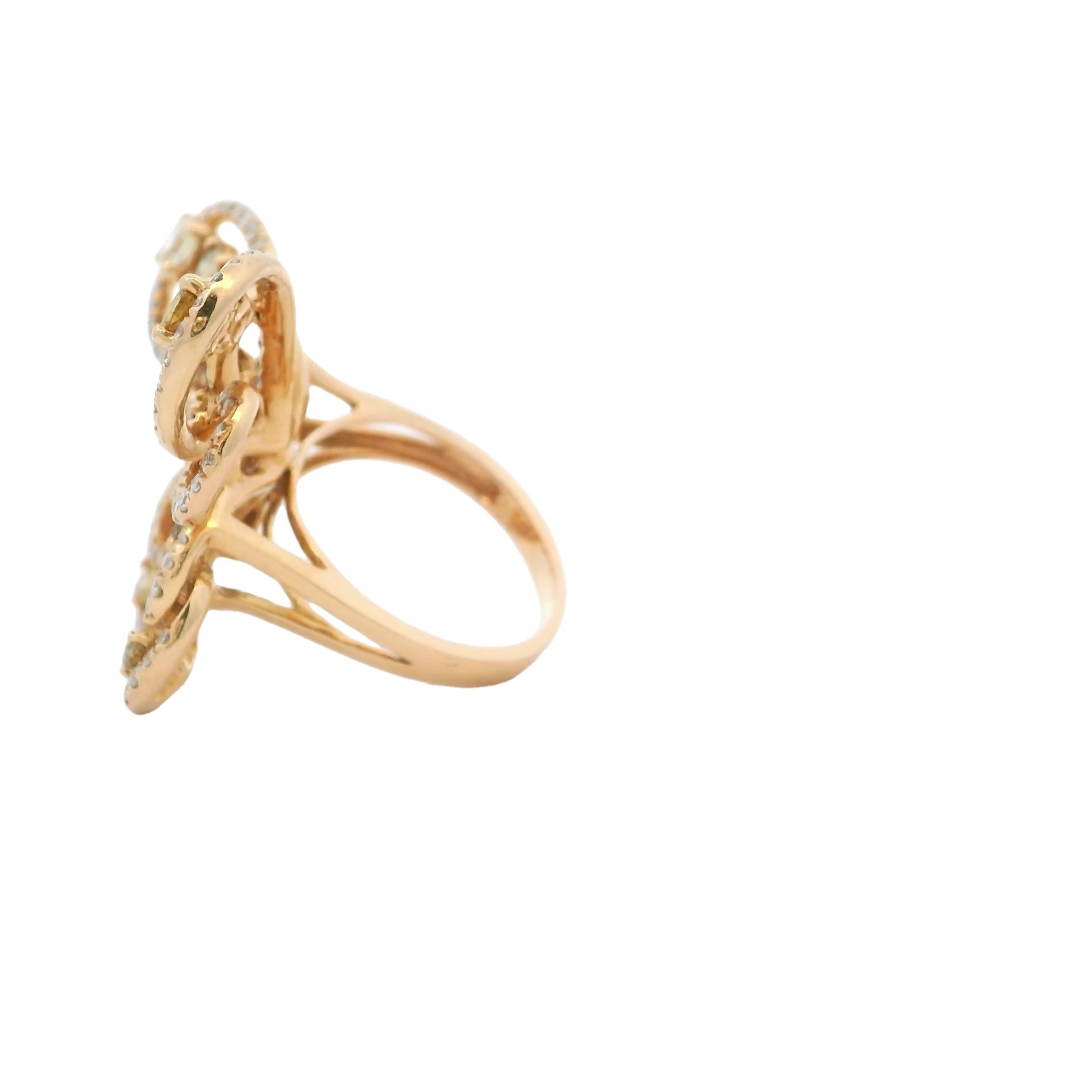 A dazzling celebration of nature and craftsmanship, this sculptural butterfly cocktail ring is crafted in 18 karat yellow gold and set with approximately 5 carats of natural fancy color diamonds. The openwork wings shimmer with a vibrant mix of
