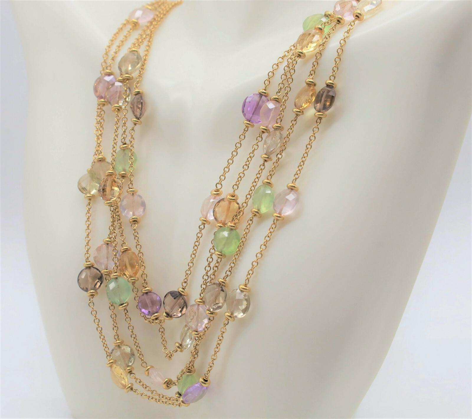 This elegant 18k yellow gold necklace features five cascading strands adorned with delicately faceted round beads in a palette of soft, translucent hues. The beads are individually wire-wrapped and evenly spaced along fine gold chains, allowing the