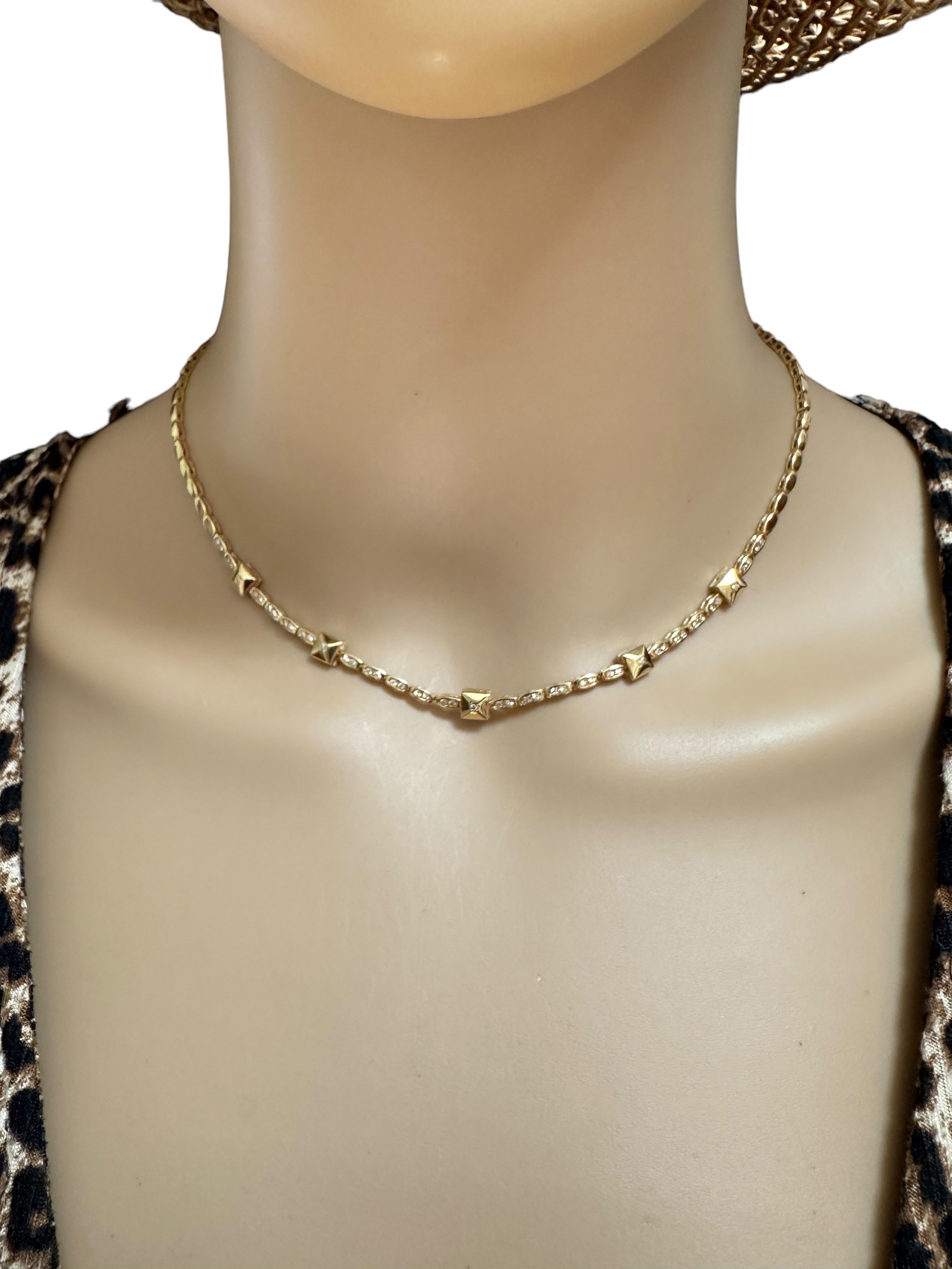 This is gorgeous quality necklace made by luxury jewelry company Rossonero.  It is high-polish gold with 5 Rockstud Stations each containing a diamond.  It is 15.5 inches long.  In total it has 49 diamonds.  5 brilliant cut diamonds on each rockstud