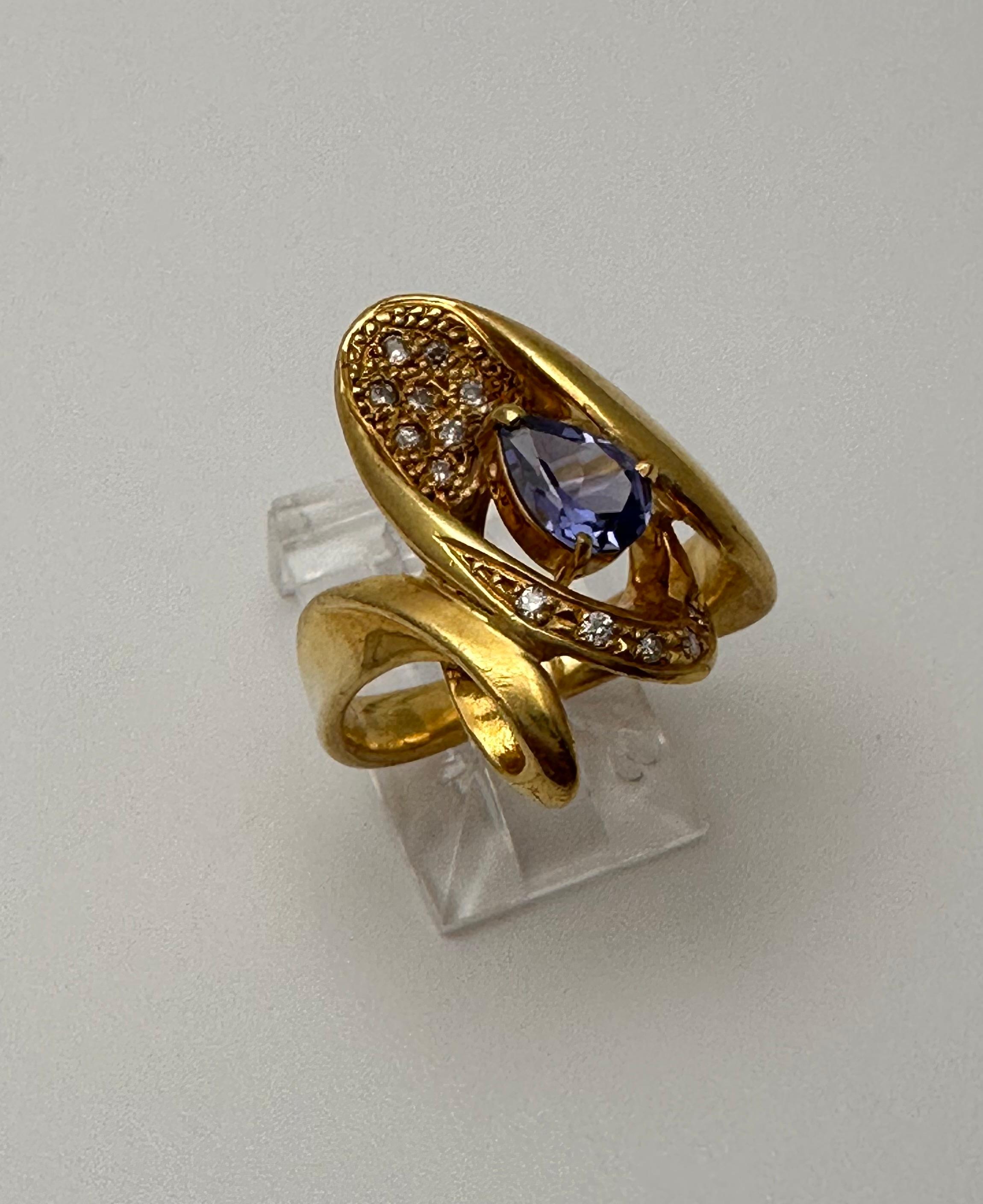 18k Yellow Gold approx.  5.5mm x 7mm Pear Tanzanite with 13 Round Diamonds 
Ring Size 7

Tanzanite 

Tanzanite changes colors when it is viewed from different directions. This shifting of colors has been said to facilitate raising consciousness. It