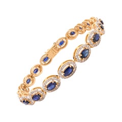 Bracelet tennis en or jaune 18 carats, saphir bleu profond et halo de diamants, 5,6 carats