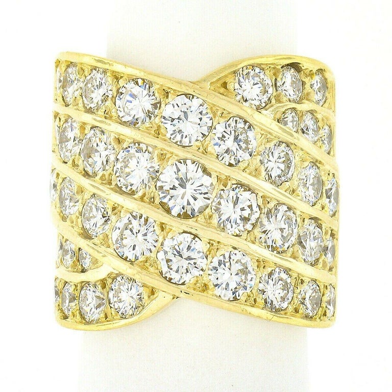 Here we have an absolutely breathtaking diamond cigar band ring crafted from solid 18k yellow gold. This fancy wide band is drenched with approximately 5.60 carats of SUPER FINE QUALITY round brilliant cut diamonds that are neatly pave set