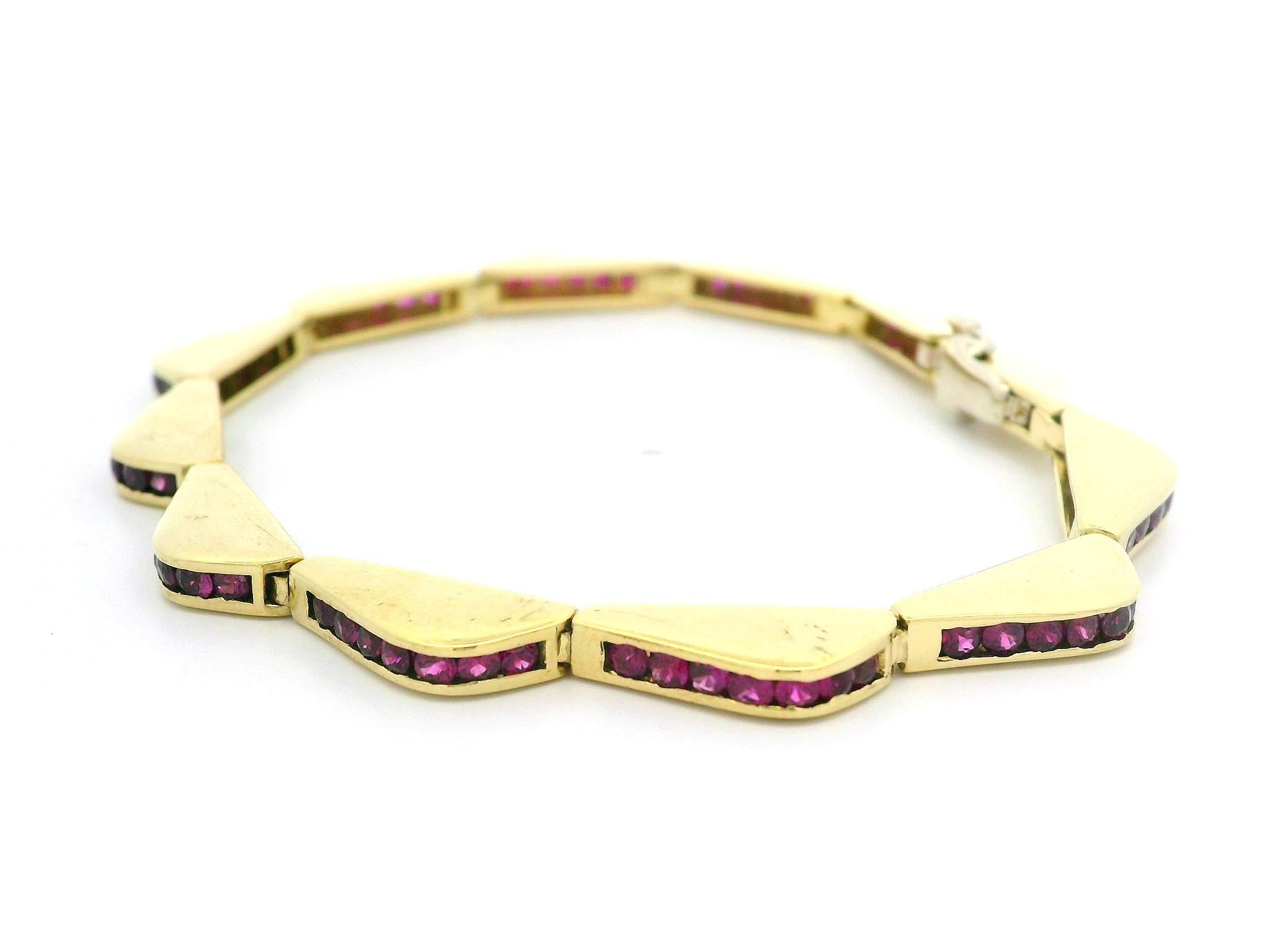 –Stone(s)–
(84) Natural Genuine Rubies - Round Brilliant Cut - Channel Set - Slightly Pinkish Red Color - Lively Clean Stones - 5ctw (approx.)

Material: Solid 18k Yellow Gold w/ White Gold Clasp
Weight: 28.60 Grams
Type: Wavy Line Link
Length: