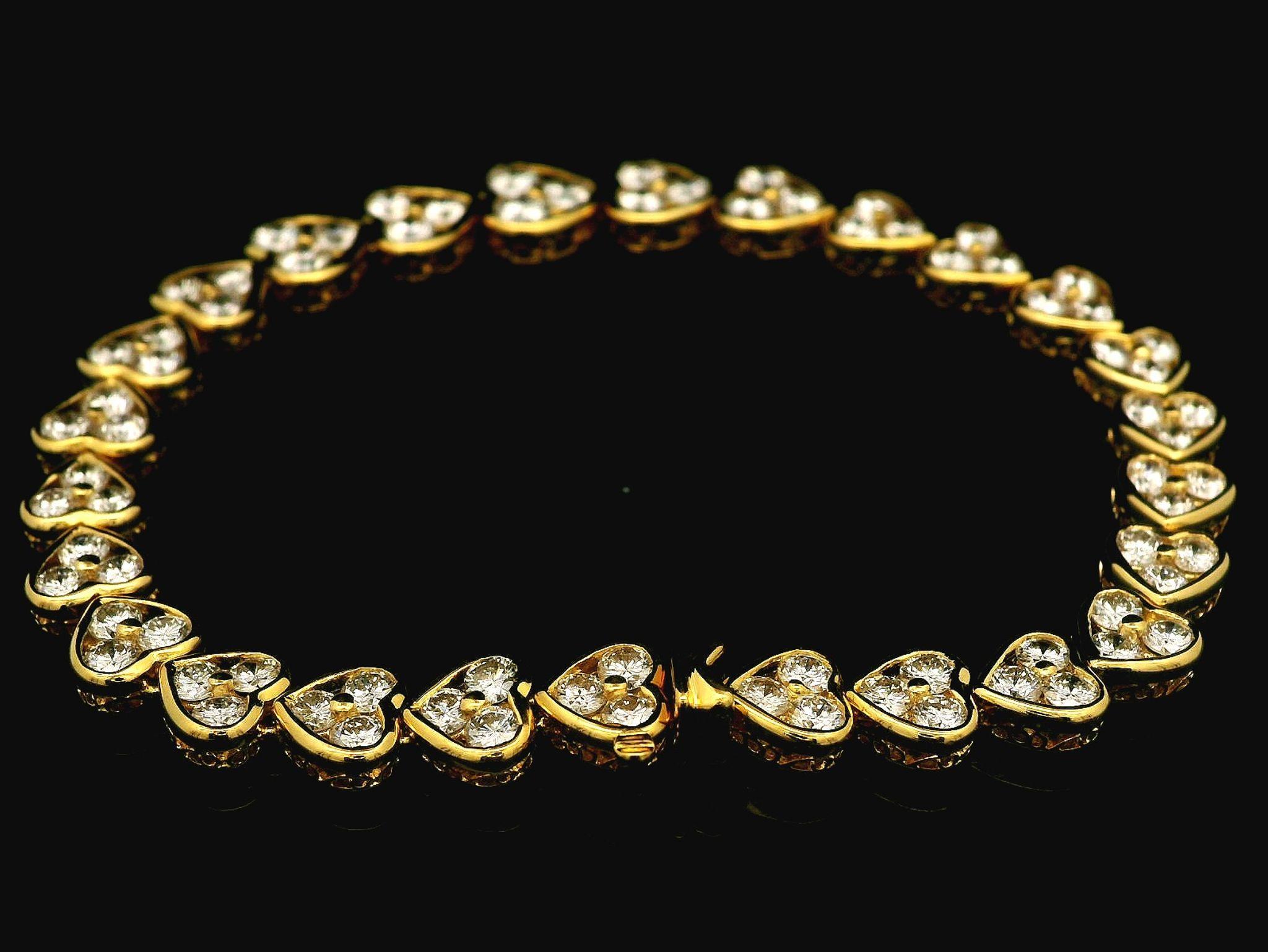 –Stone(s)–
(78) Natural Genuine Diamonds - Round Brilliant Cut - Prong & Channel Set - F/G Color - VVS-VS Clarity - 0.15ct (largest. approx.) - 6.26ctw (exact)

Material: Solid 18k Yellow Gold
Weight: 13.94 Grams
Type: Graduated Heart Line Link