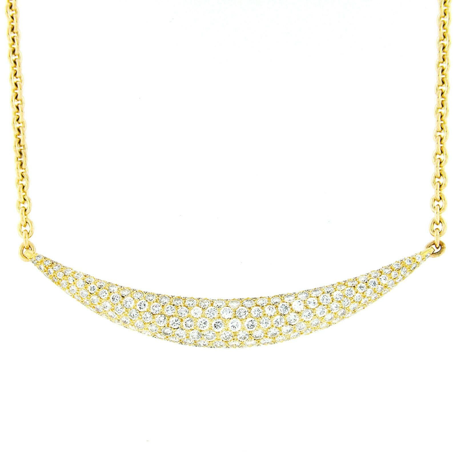 This absolutely outstanding diamond necklace was crafted from solid 18k yellow gold. It features an elegant, curved, and domed bar pendant design that is completely paved with 201 very well cut round brilliant diamonds that total approximately 6.75