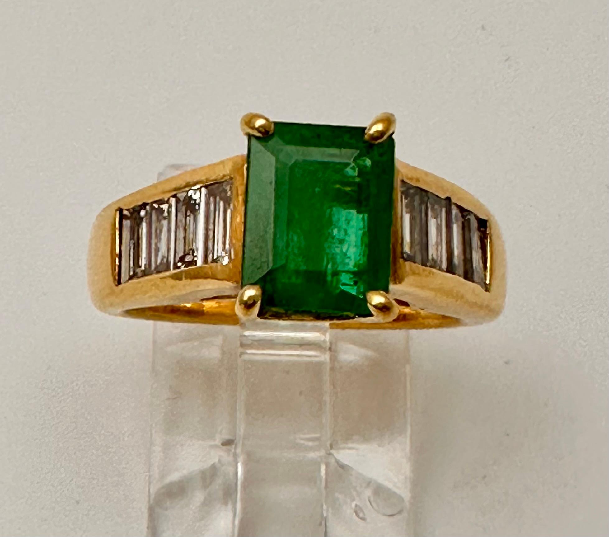 18k Yellow Gold approx. 6mm x 8mm Emerald Shape Emerald and 8 side Baguette Diamonds
Ring Size 5 1/2
Emerald approx 1.75 ct

This stunning 18k yellow gold ring boasts a beautiful emerald shape emerald and diamond design, with a total of 8 natural